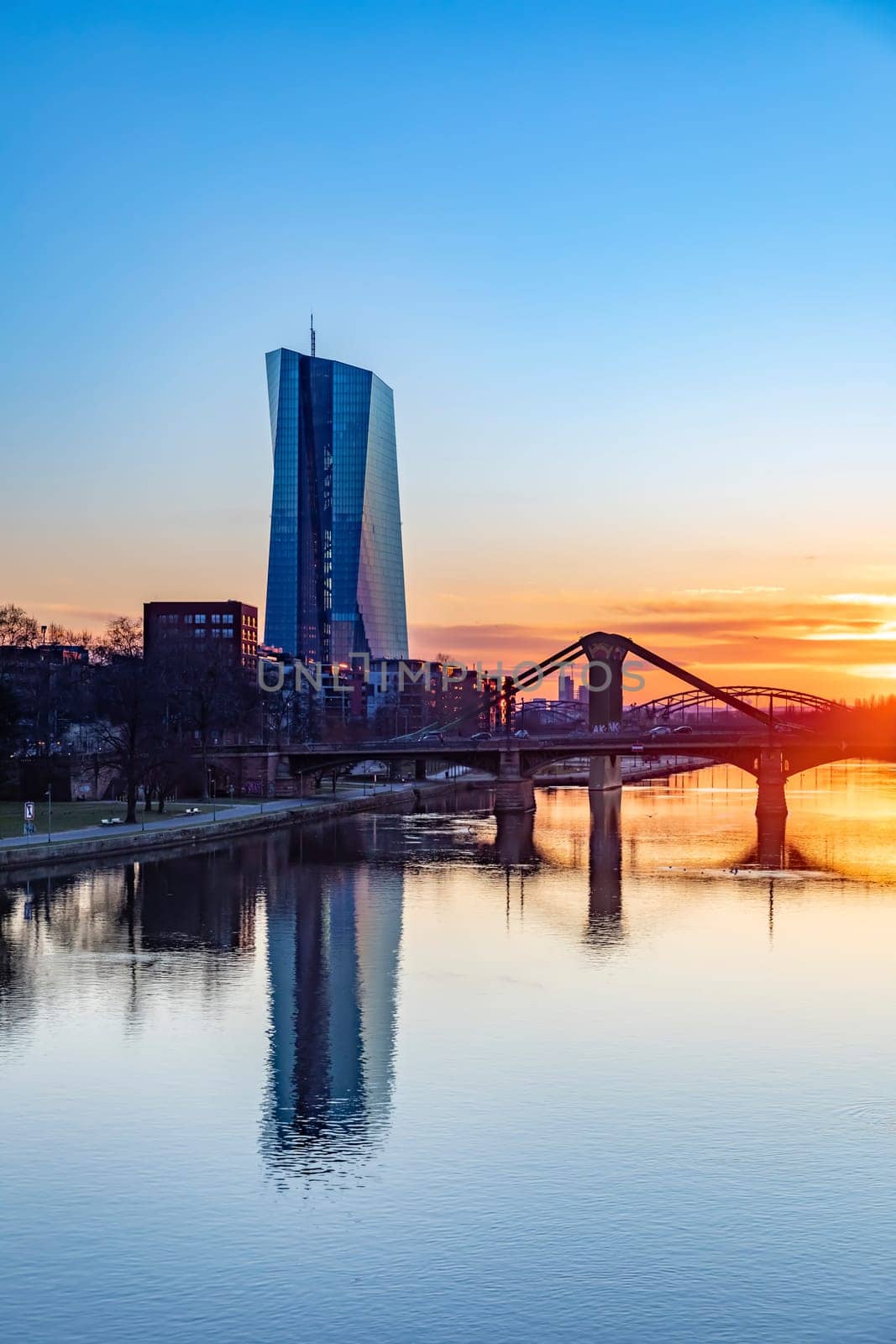 Frankfurt, Germany - February 28, 2023: scenic view to skyline of Frankfurt am Main with reflection of the european central bank in river Main.