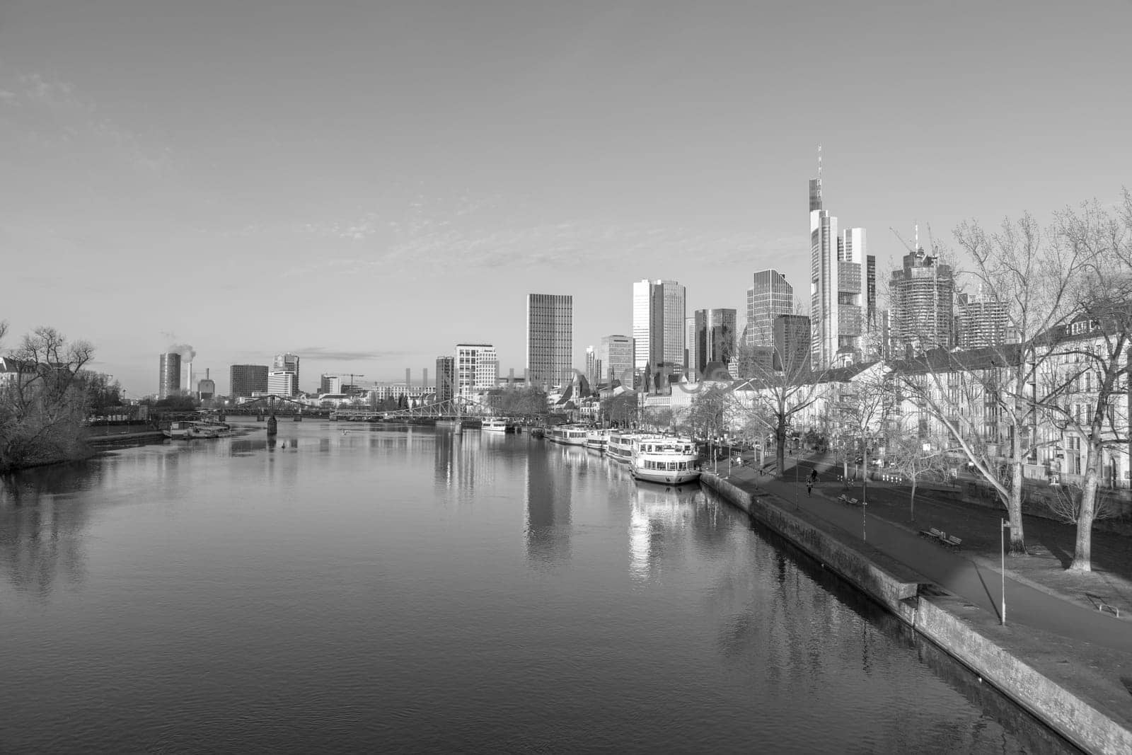 Frankfurt, Germany - February 28, 2023: scenic view to skyline of Frankfurt am Main with reflection of the skyline in river Main.