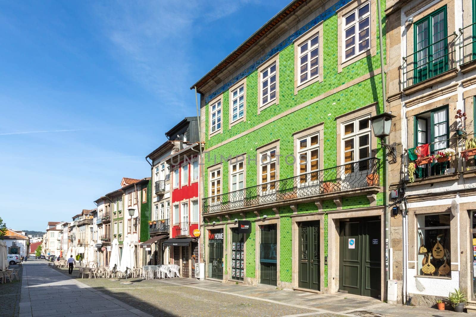 Braga, Portugal - May 1, 2023:street scene in the old town of Braga with historic facades and people in early morning.
