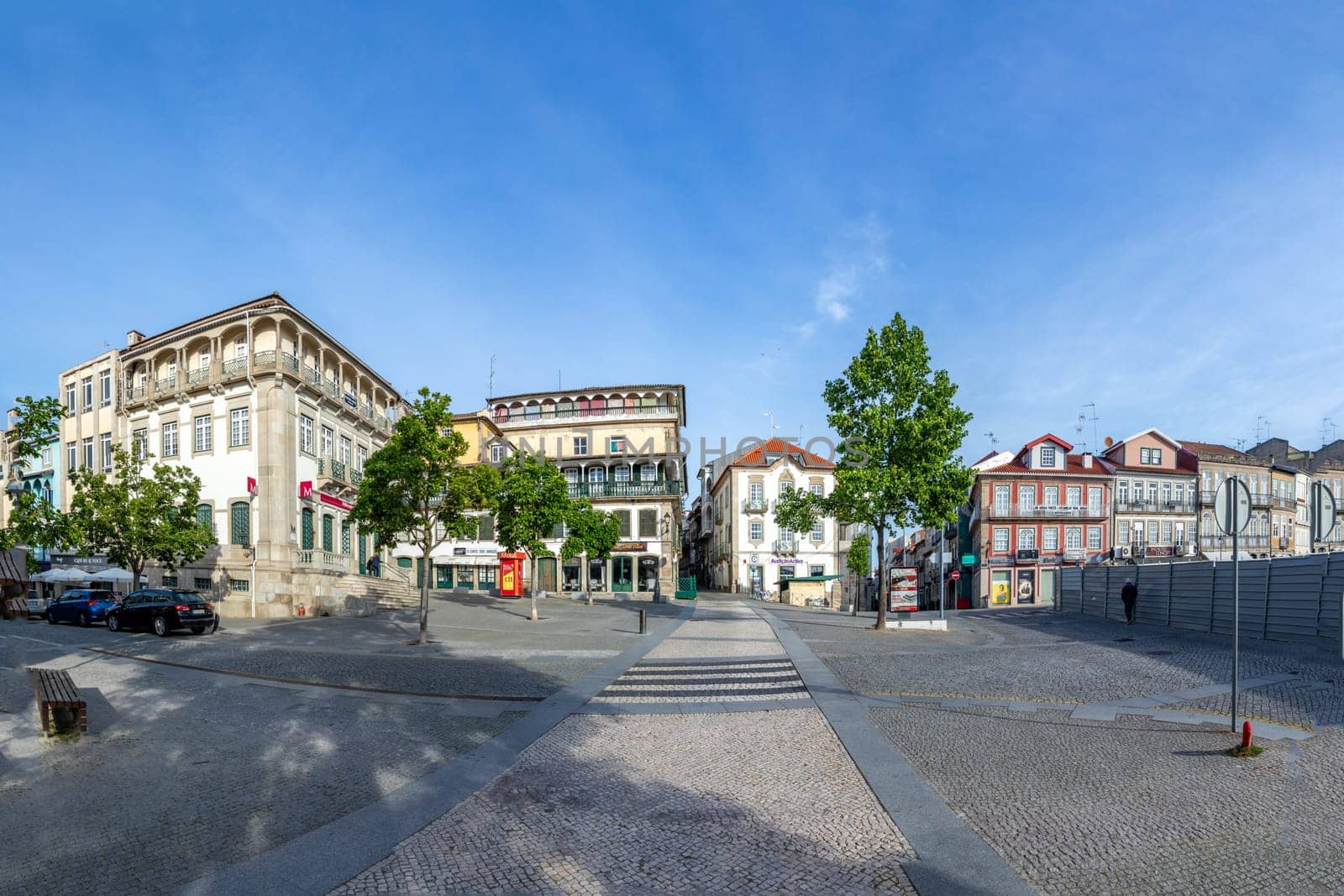 Chaves, Portugal - May 1, 2023: scenic narrow street in Chaves in early morning light with cobble stones and old historic houses.
