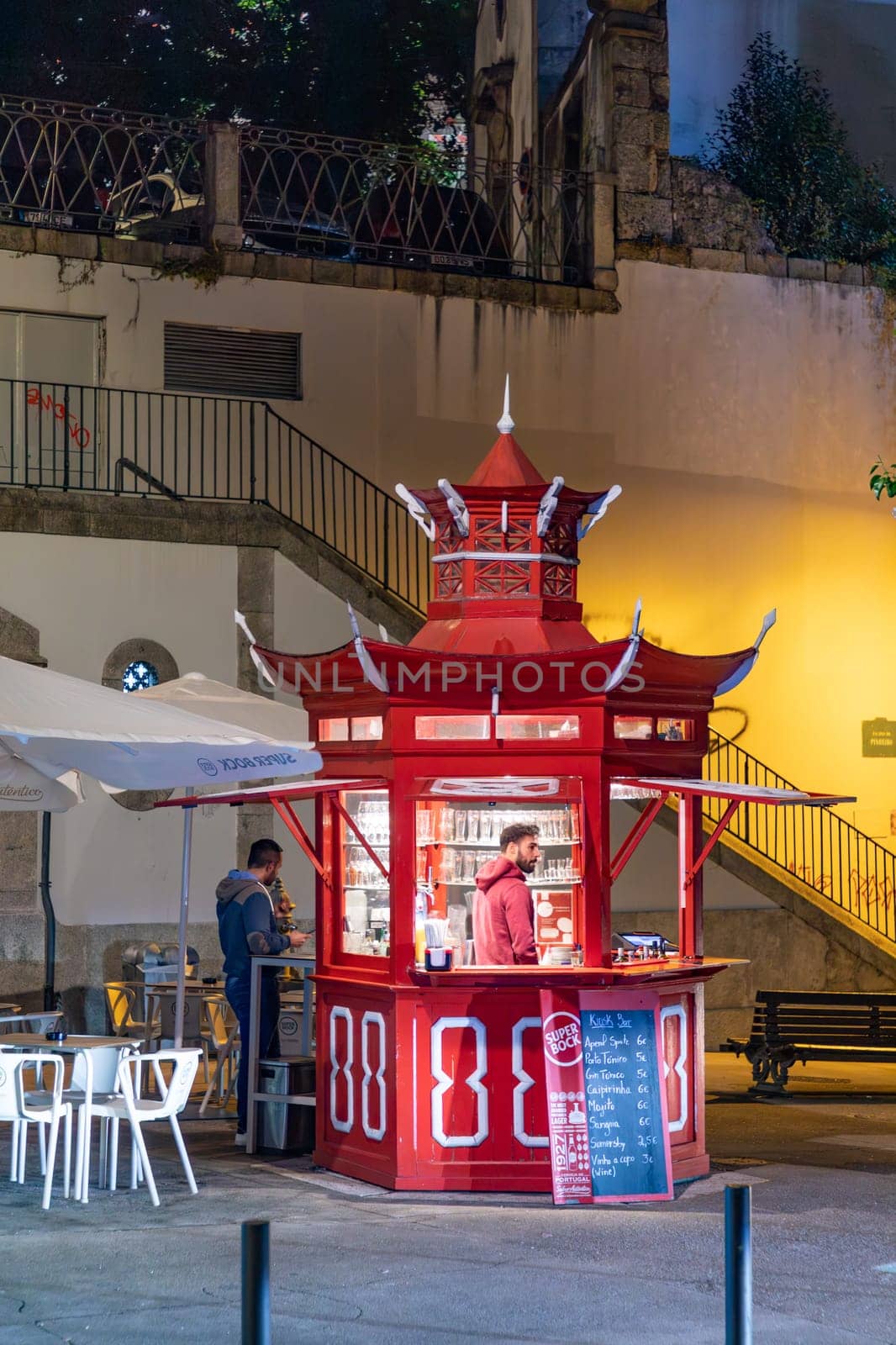 Porto, Portugal - May 3, 2023: open kiosk in chinese style offers food to people even in the night in Porto.
