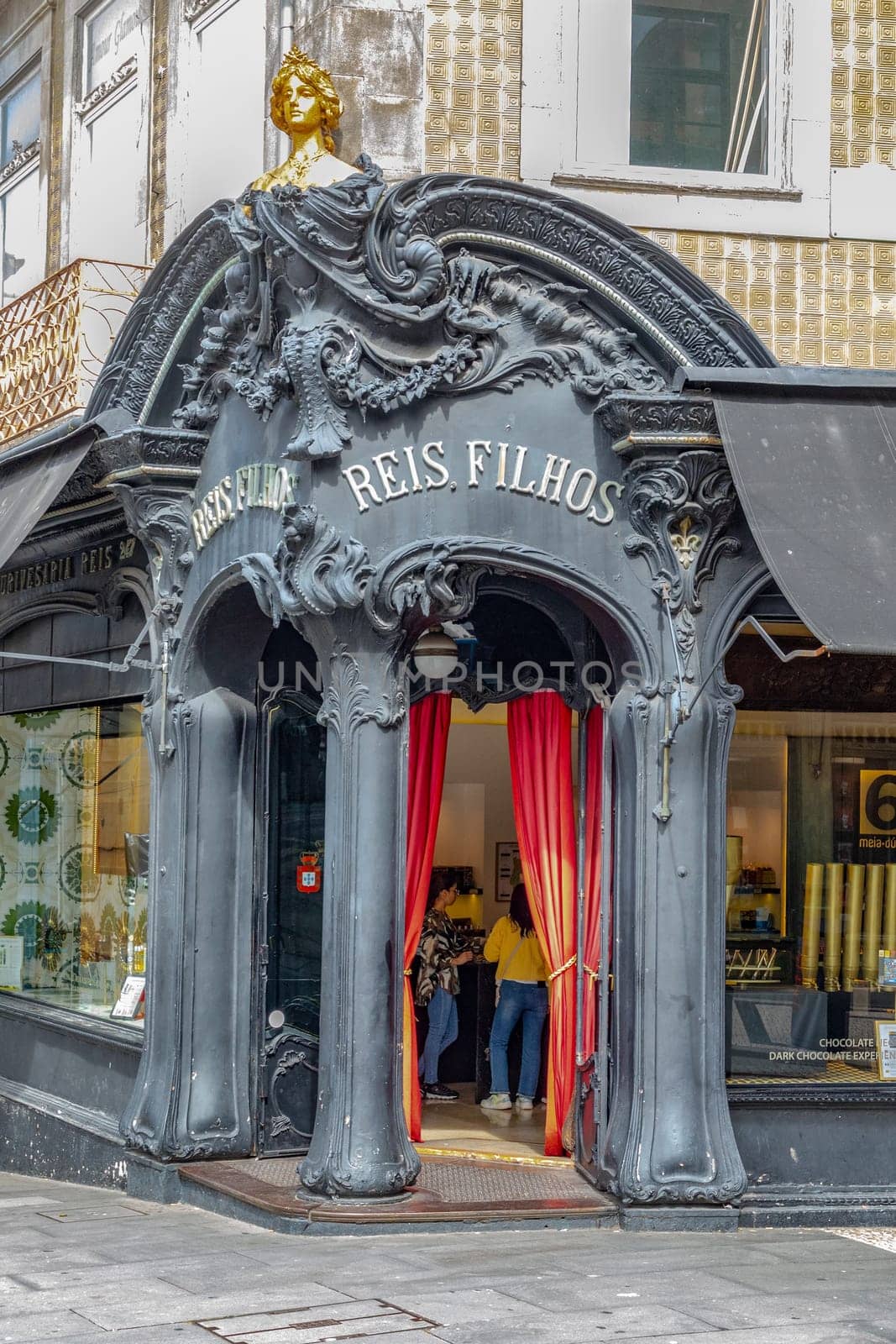 Porto, Portugal - May 3, 2023: view of the liberty decorated entrance of Reis Filhos, an historic shop in Porto