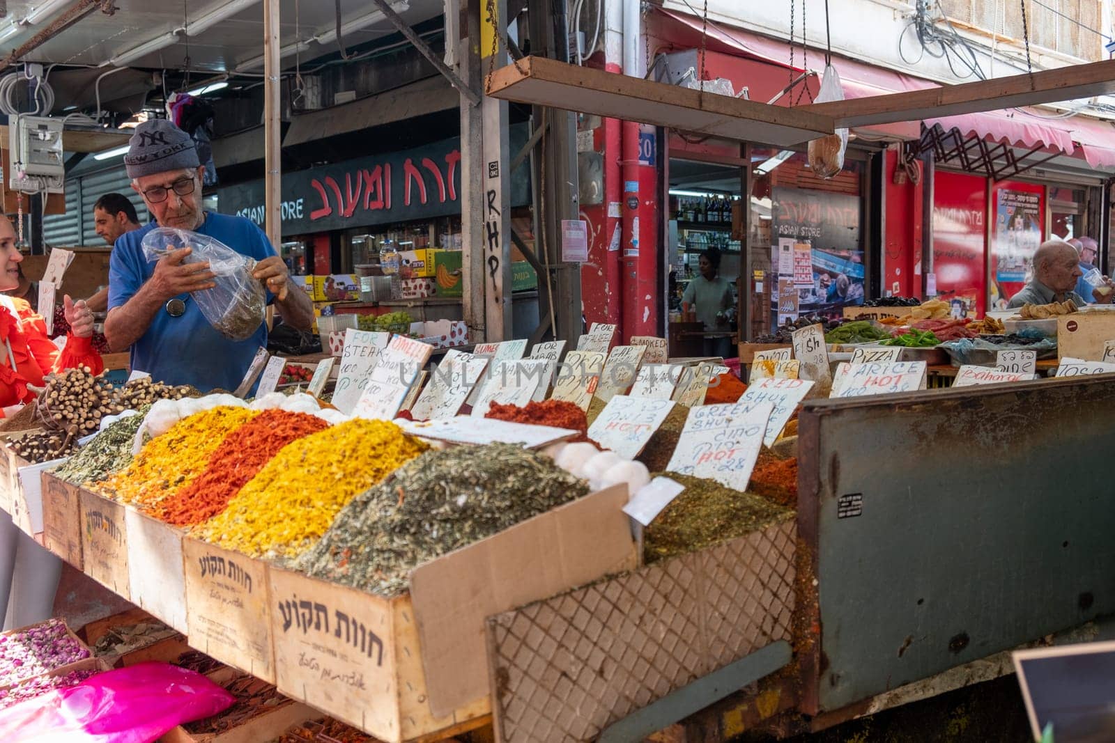 Tel Aviv, Israel - May 18, 2023 :Israeli people shopping at Carmel Market (Shuk HaCarmel) in Tel Aviv, Israel.It's a very popular marketplace in Tel Aviv sells mostly food and home accessories goods.