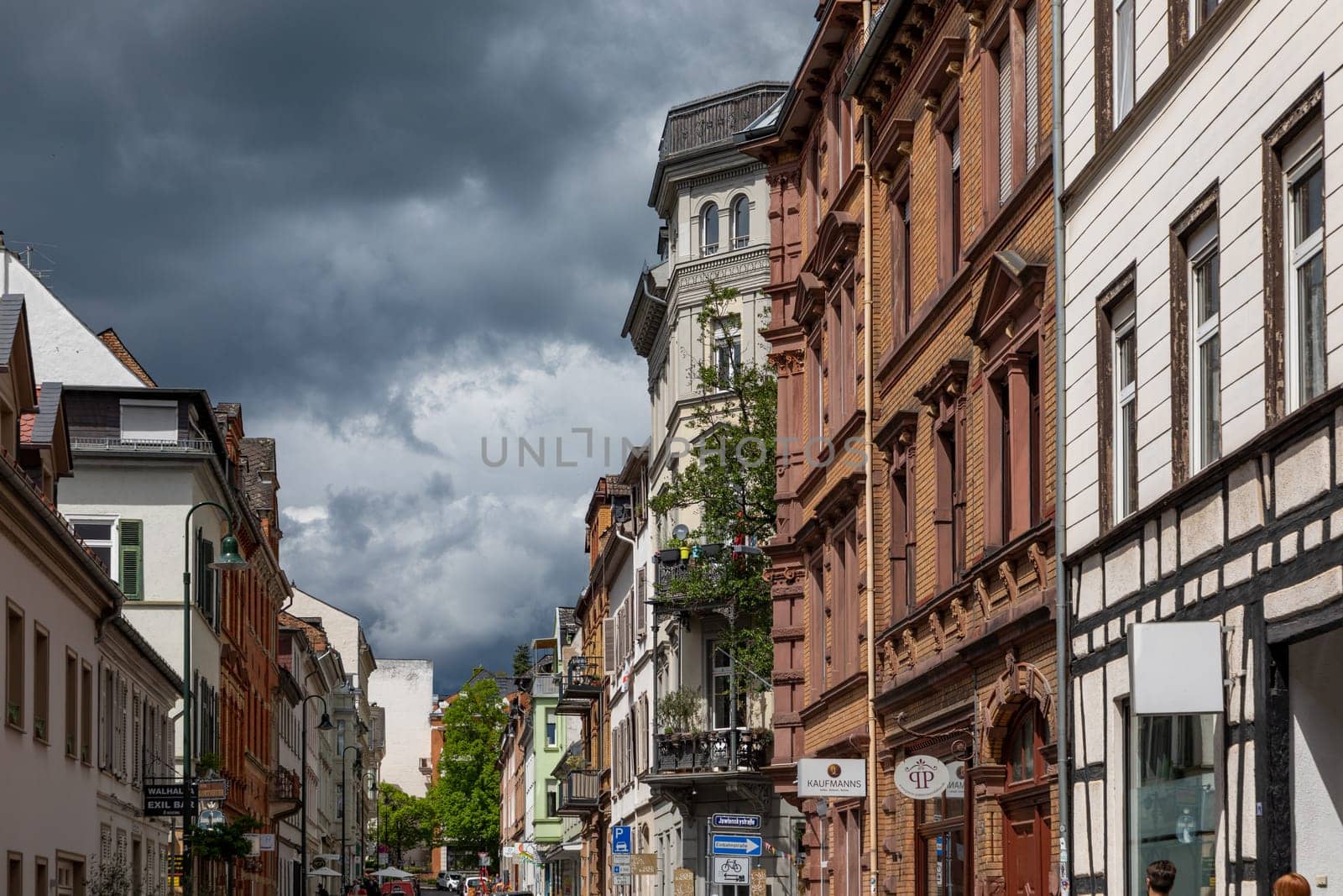 Wiesbaden, Germany - May 6, 2023: view to old historic Nerostrasse - engl: street of Neero - in bad weather situation with dark clouds.