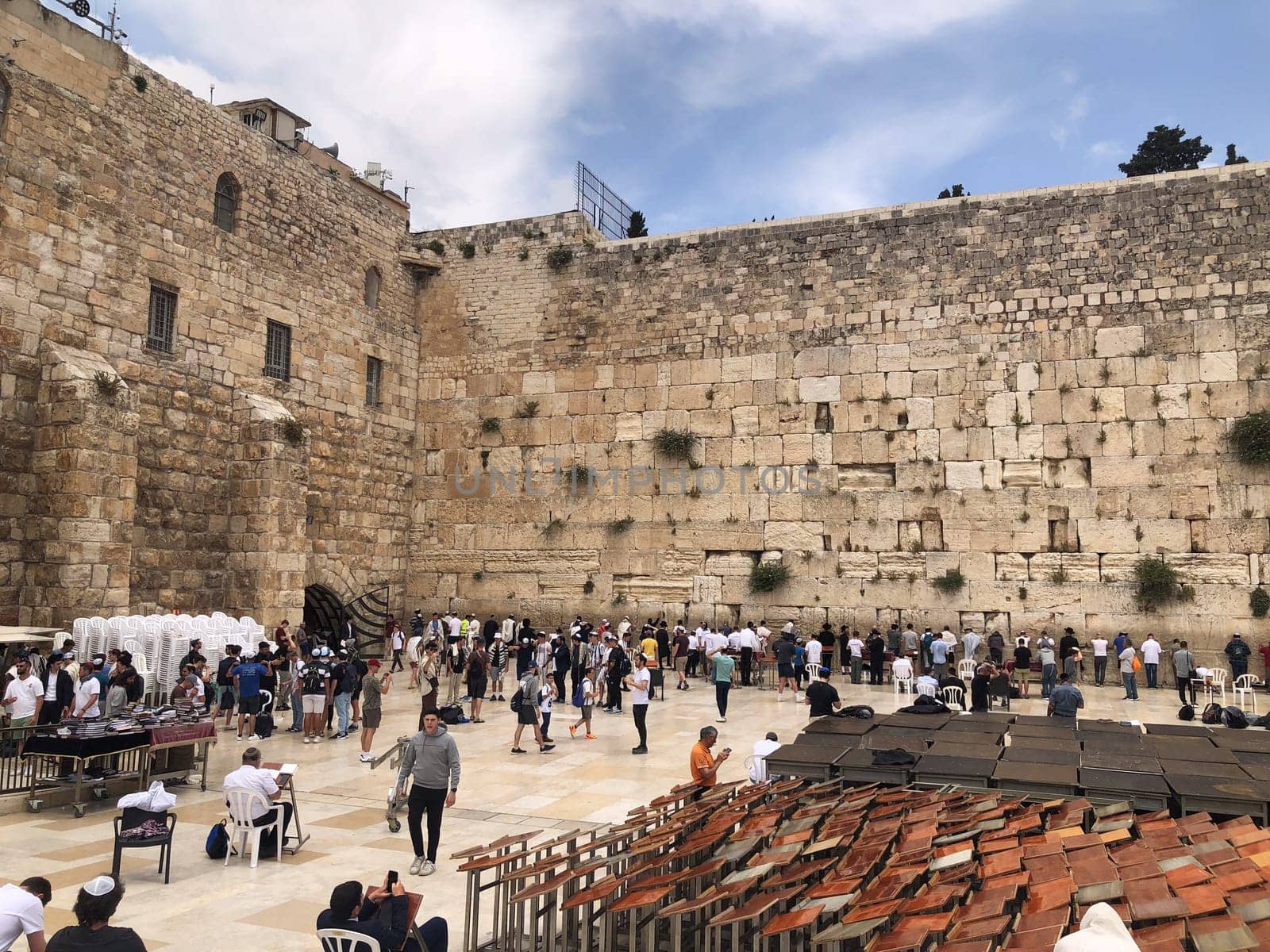Jerusalem, Israel - May 19, 2023: Jewish worshipers are praying at the Wailing Wall in Jerusalem, Israel.