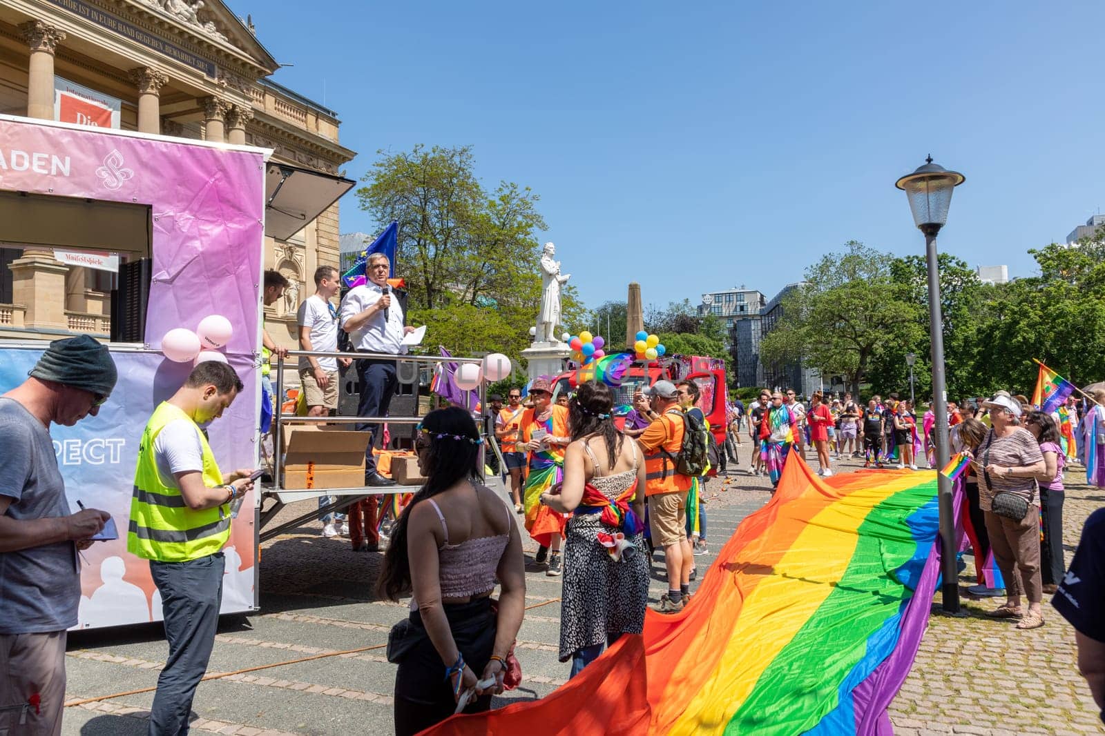Wiesbaden, Germany - May 27, 2023: people enjoy the christopher street parade in Wiesbaden with rainbow flags and beaufiful costumes.