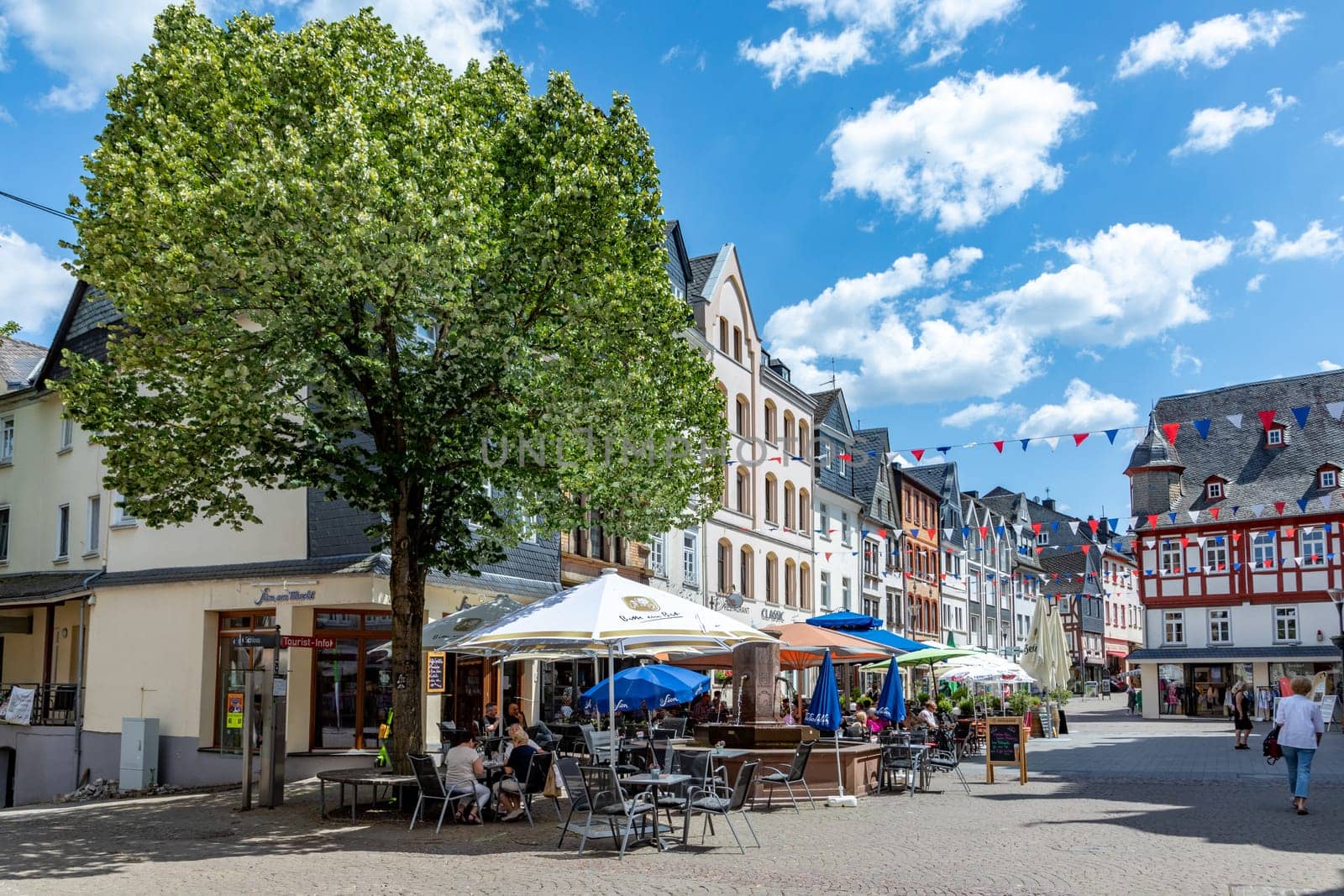 Montabaur, Germany - June 15, 2023: people enjoy visiting old town of Montabaur with lovingly restored half-timbered buildings from the 16th and 17th centuries.