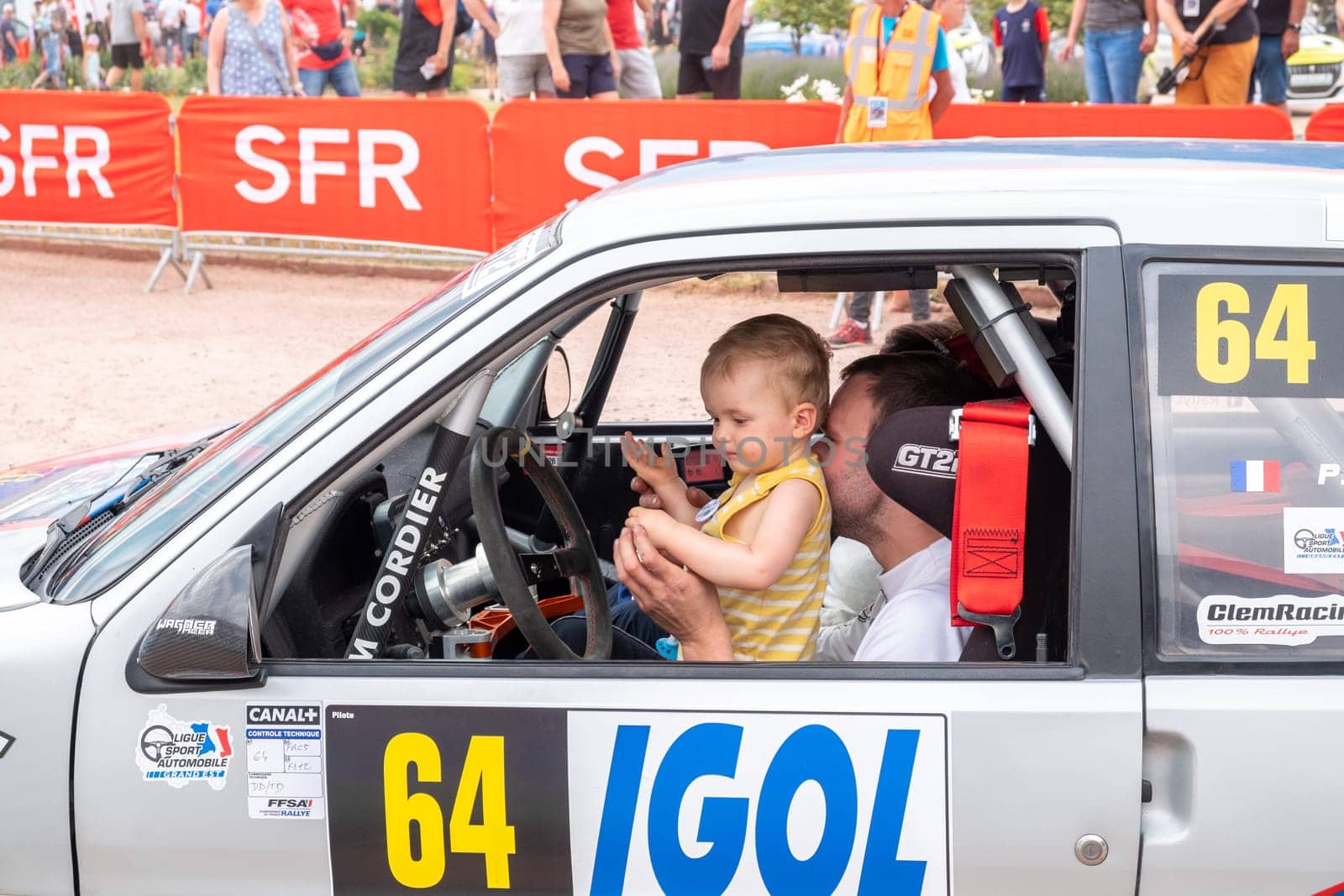 Geraldmer, France - June 18, 2023: rally driver with his child at the drivers position on the way to the official welcome greeting of the geraldmer rally trophy.