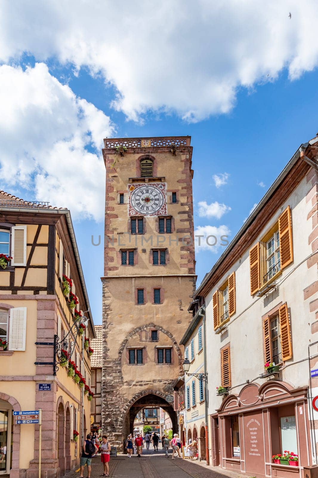 Ribeauville, France - June 23, 2023: A picturesque colorful street of half-timber buildings with shops and cafes in the village of Ribeauville, in the Alsace region.