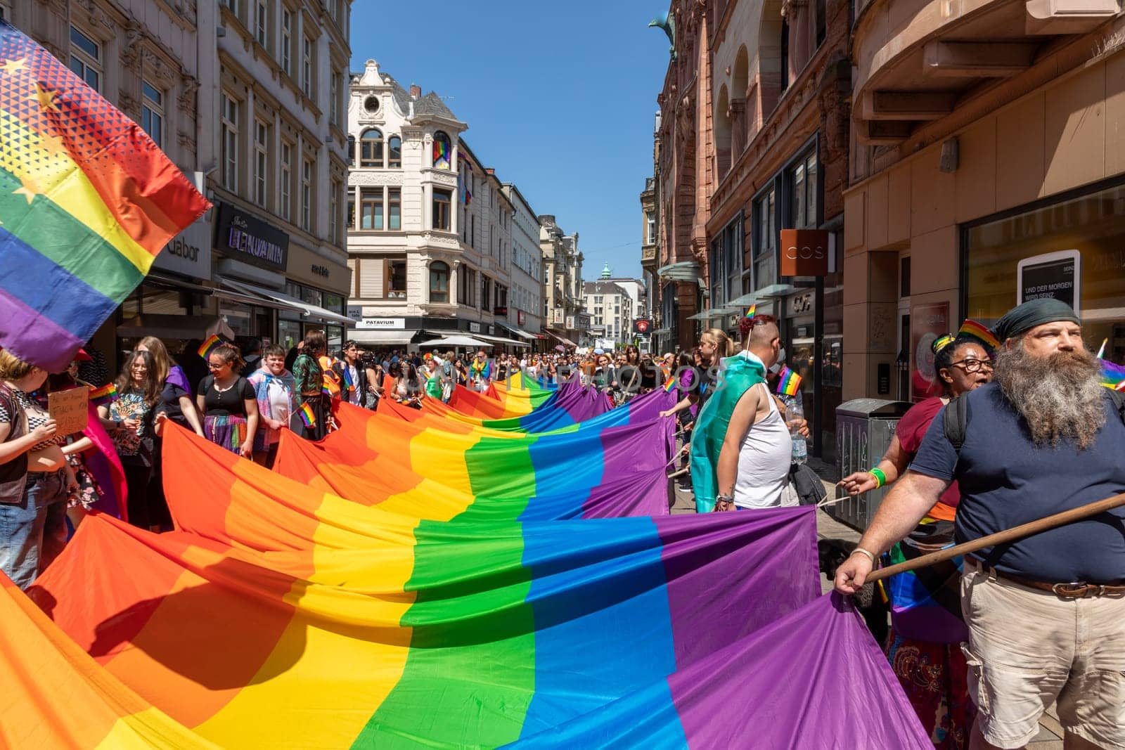 Wiesbaden, Germany - May 27, 2023: people enjoy the christopher street parade in Wiesbaden with rainbow flags and beaufiful costumes.