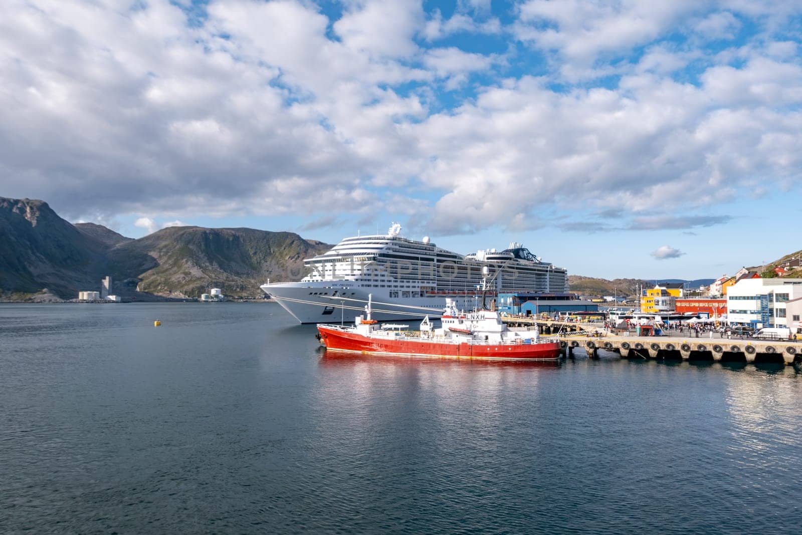 Honni9ngsvag, Norway - August 24, 2023: Troms og Finnmark, Honningsvag, view from the sea, Norway with cruise ship MSC Preziosa at the pier.