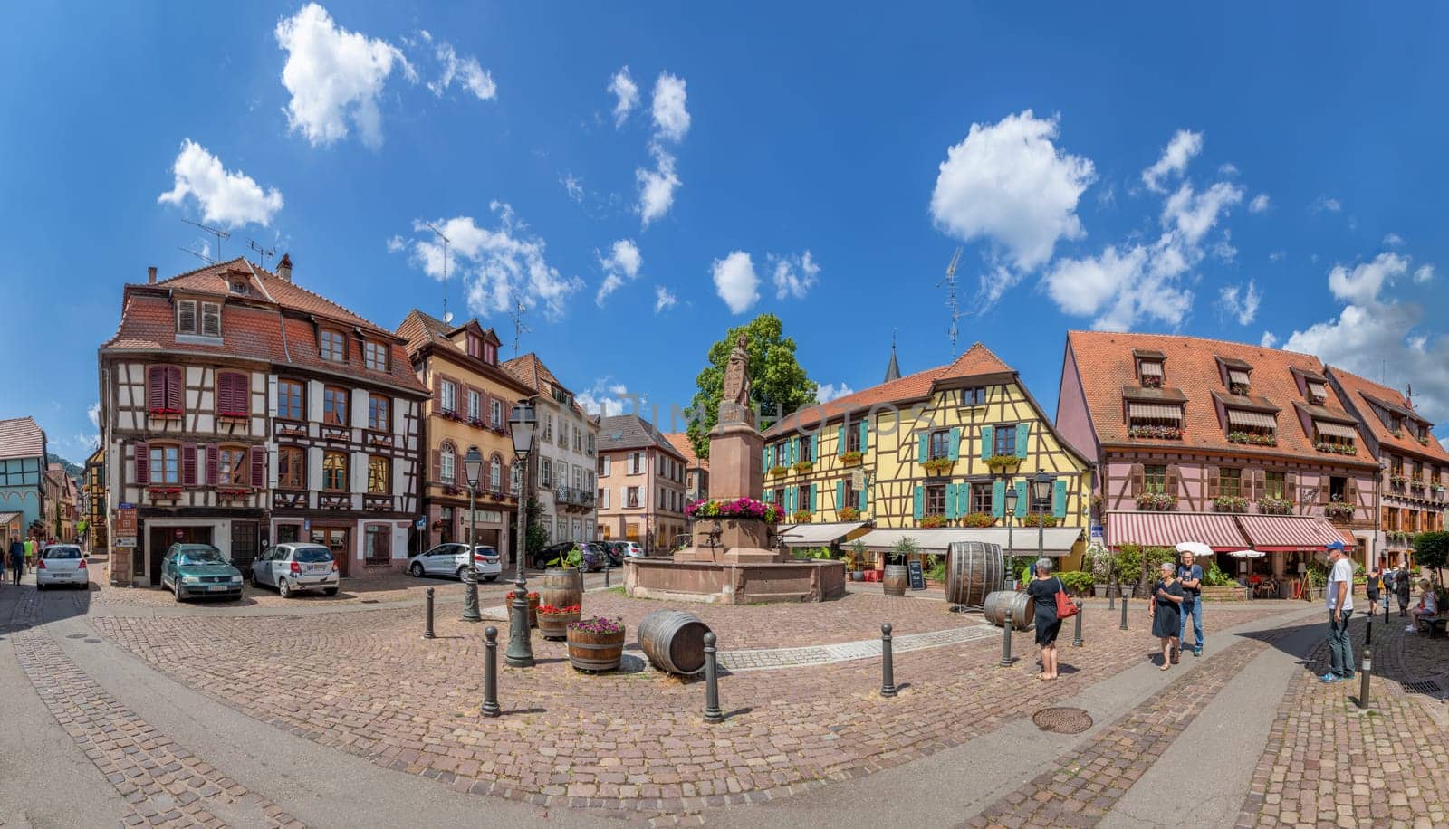 Ribeauville, France - June 23, 2023: A picturesque colorful street of half-timber buildings with shops and cafes in the village of Ribeauville, in the Alsace region.