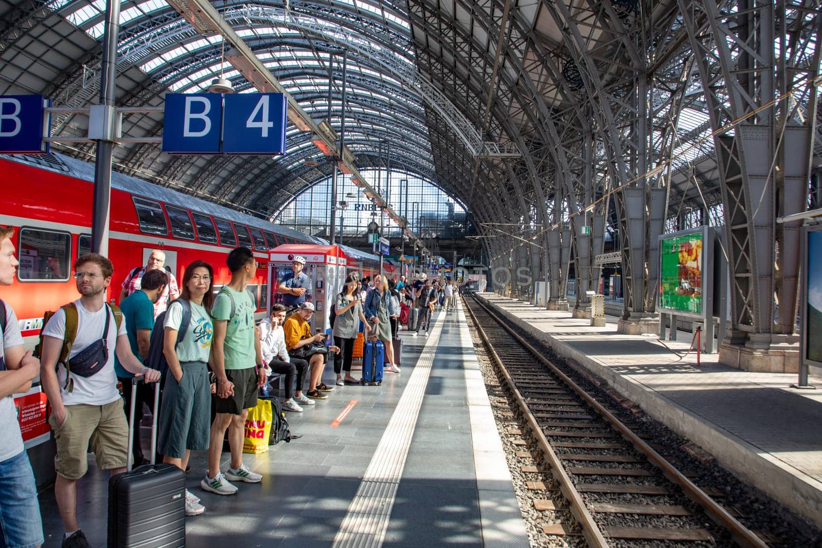 Frankfurt, Germany - September 11, 2013: people at Frankfurt train station wait for the train. Most of them hold a 49 Euros reduced germany ticket.