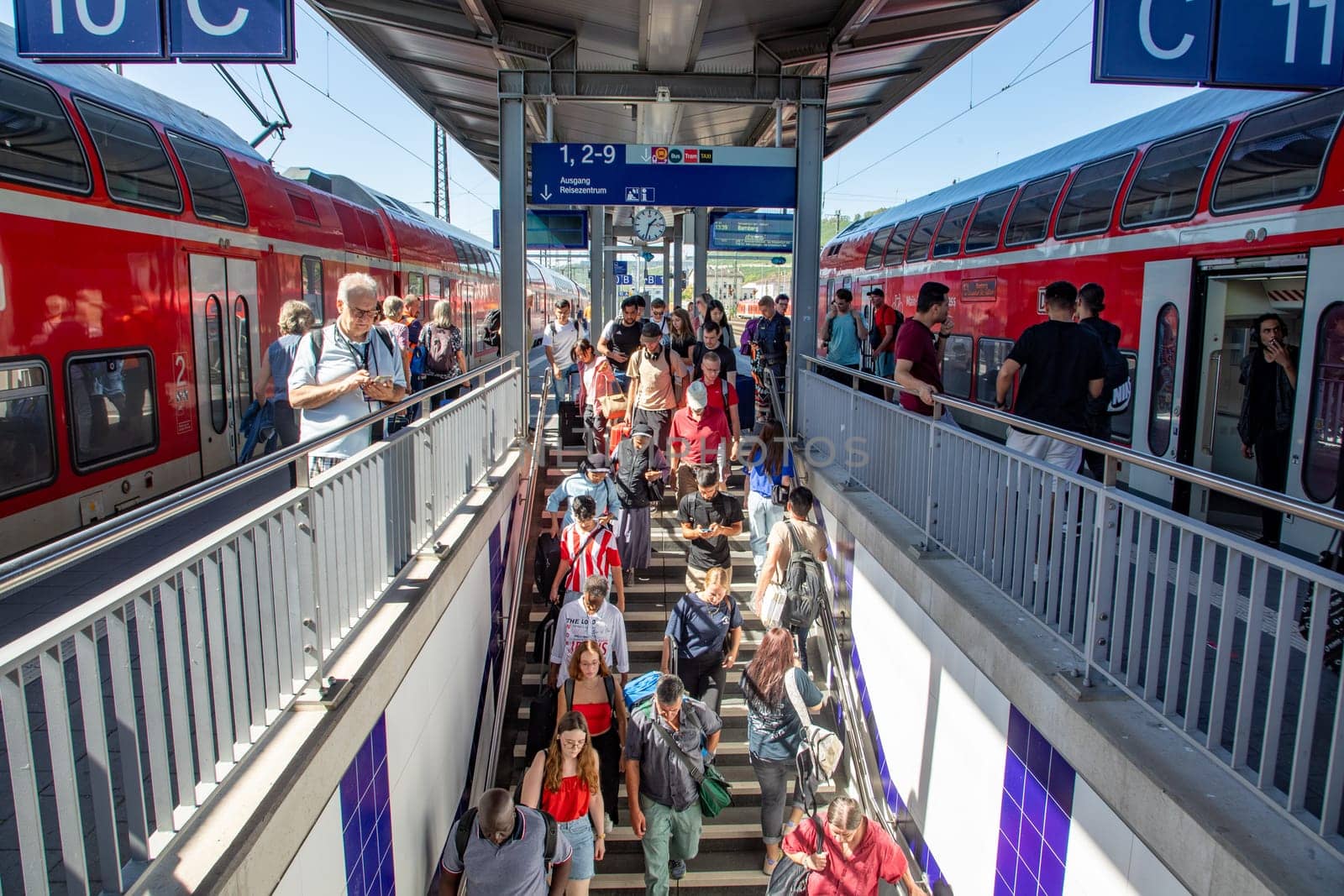Würzburg, Germany - September 11, 2013: people at Würzburg train station wait for the train. Most of them hold a 49 Euros reduced germany ticket.