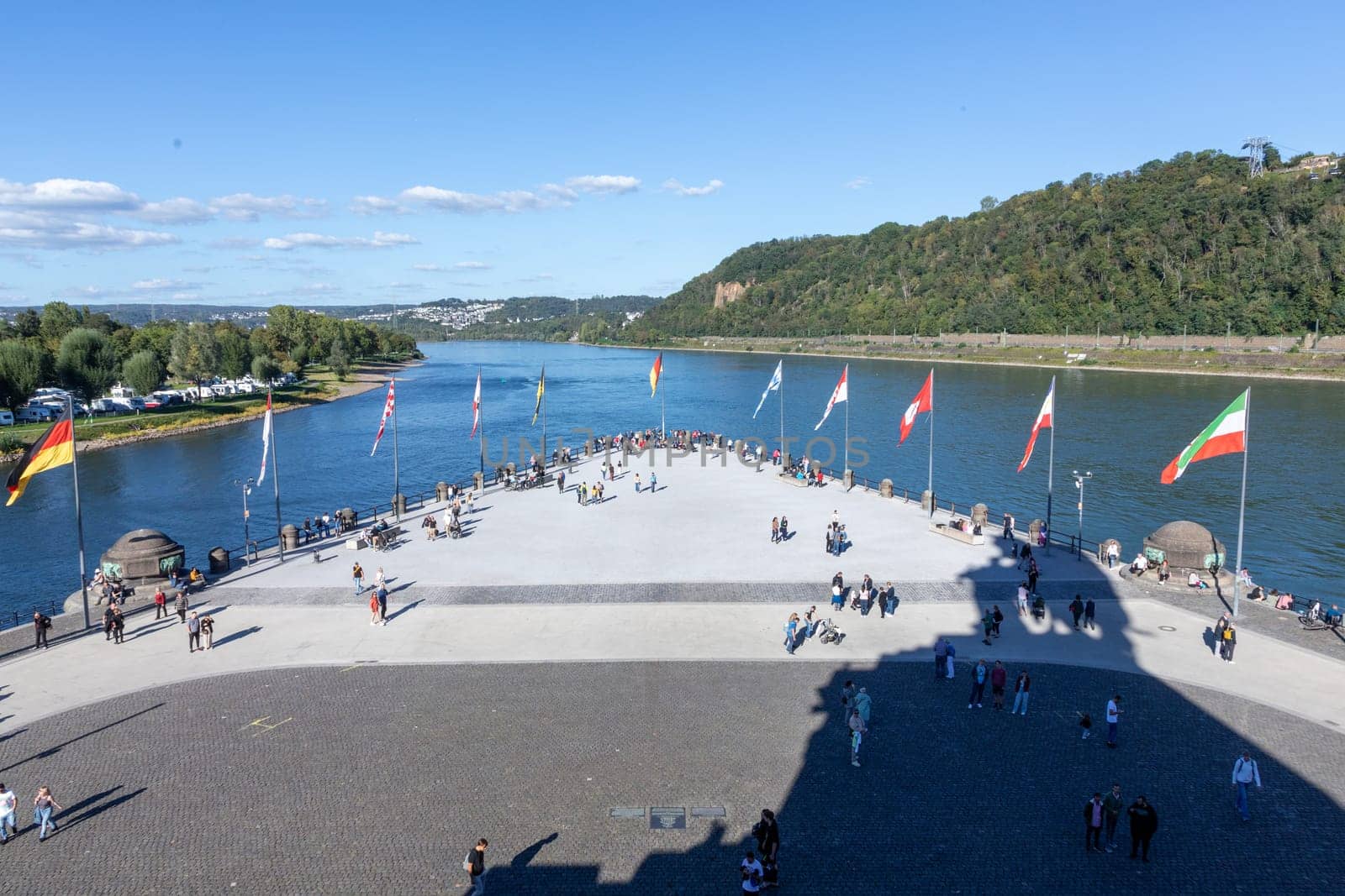 Koblenz, Germany - September 24, 2023: people promenade at river Rhine  in Koblenz at Deutsches Eck or German Corner in Koblenz, where the Mosel river joins the Rhine.