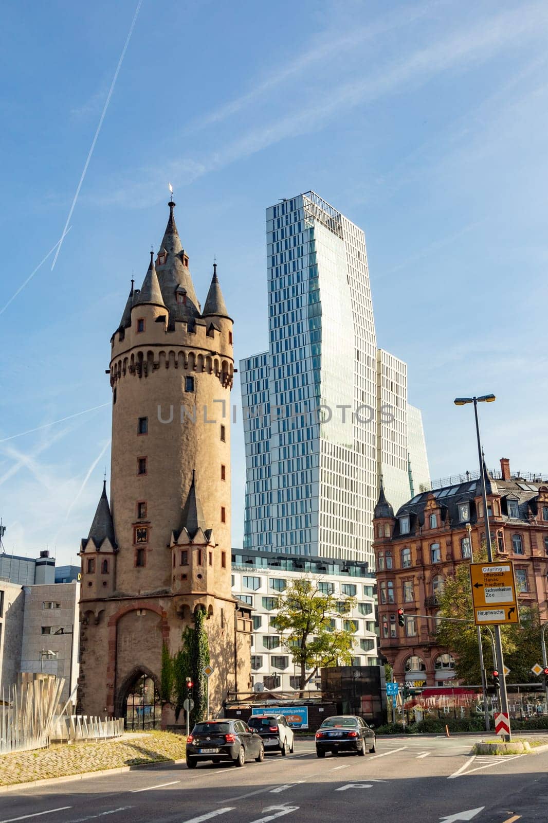 Frankfurt, Germany - October 10, 2023: view to old city gate and tower Eschesheimer Turm and modern hotel Jumeirah in Frankfurt, Germany.