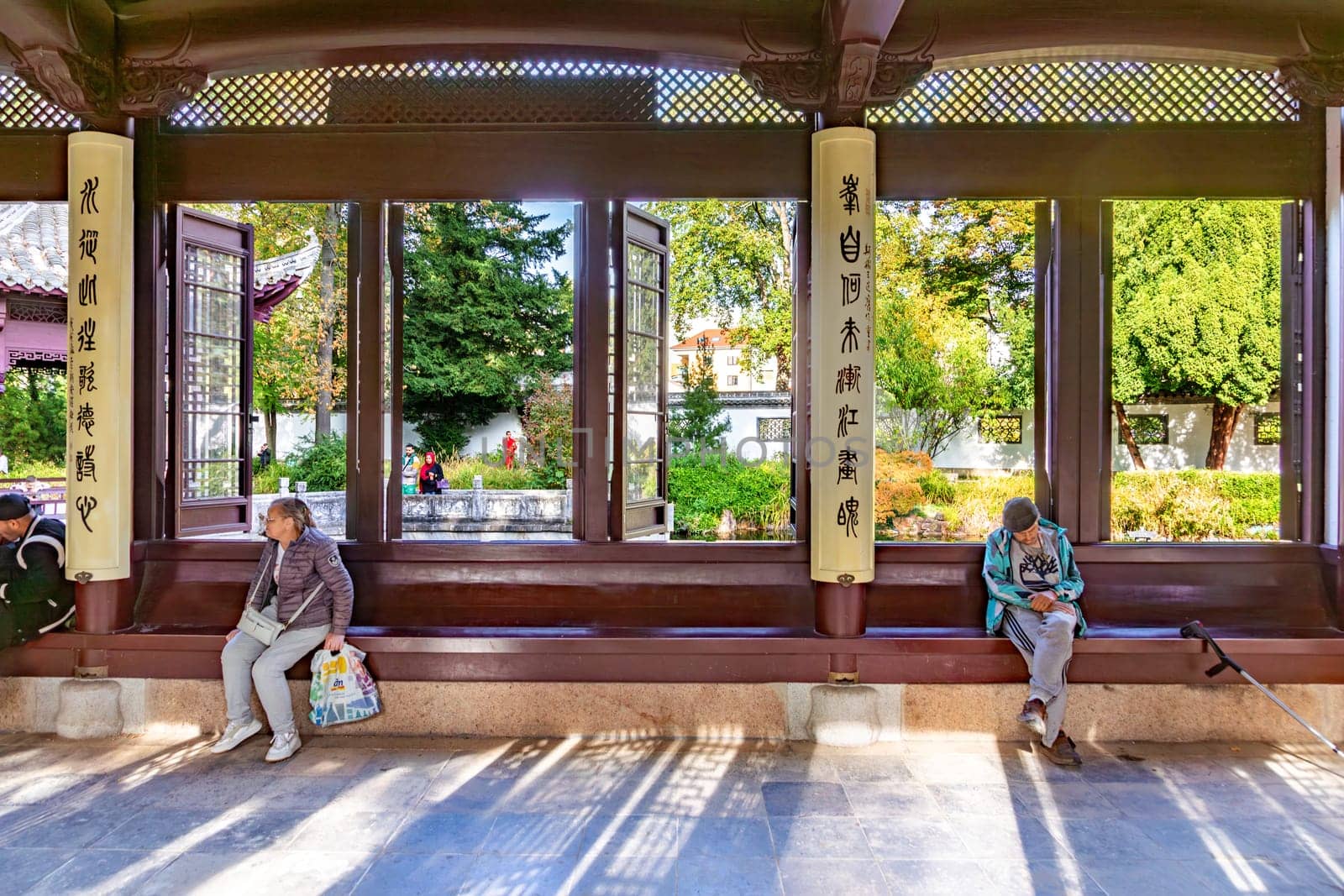 Frankfurt, Germany - October 10, 2023: people enjoy the chinese garden in the von Bethmann park in Frankfurt, Germany