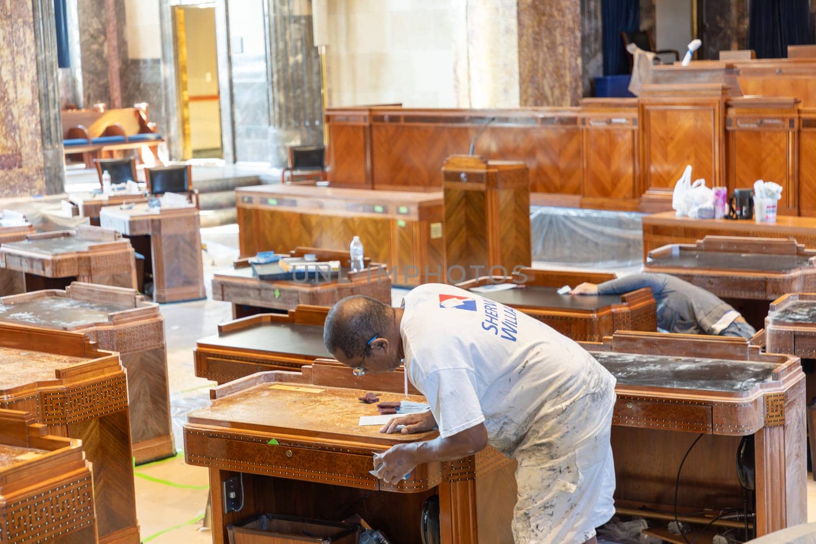Baton Rouge, USA - October 23, 2023: inside the state capitol building in Baton Rouge, USA. Worker are cleaning the old wooden tables of the members of Senate.