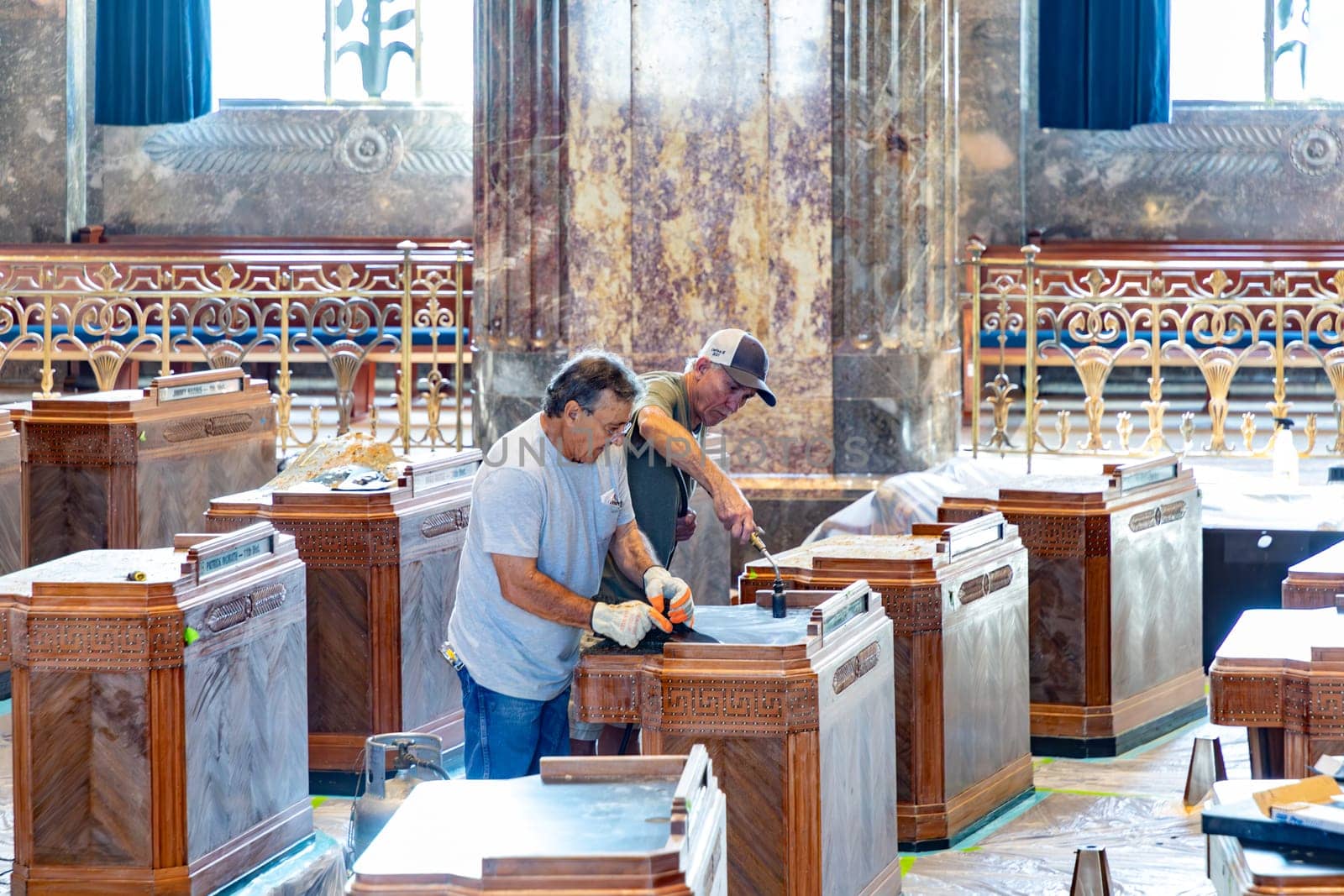 Baton Rouge, USA - October 23, 2023: inside the state capitol building in Baton Rouge, USA. Worker are cleaning the old wooden tables of the members of Senate.