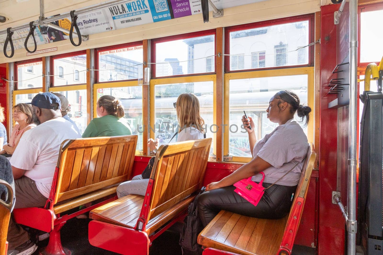 New Orleans, USA - October 24, 2023: people ride in the historic red street car at Cannal street in New Orleans.