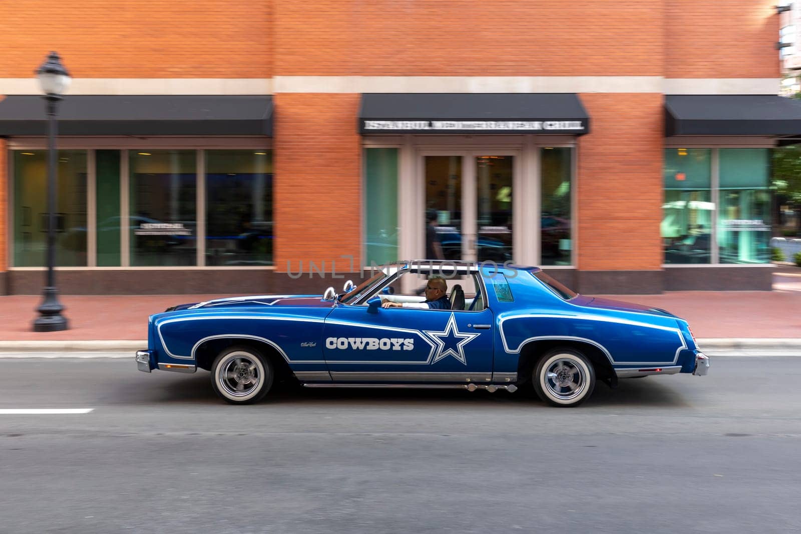 Fort Worth, Texas - November 4, 2023: old 1974 Chevrolet Monte Carlo pimped with letter Cowboy crusing in downtown Fort Worth.