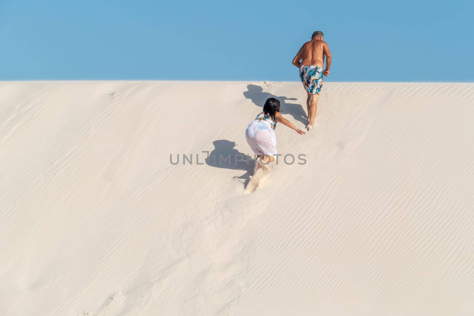 Atins, Brazil - December 23, 2023: people enjoy visiting the lagoa bonita - beautiful sea in the desert dune landscape Lencois Maranhenses National Park - Parque Nacional dos Lencois Maranhenses