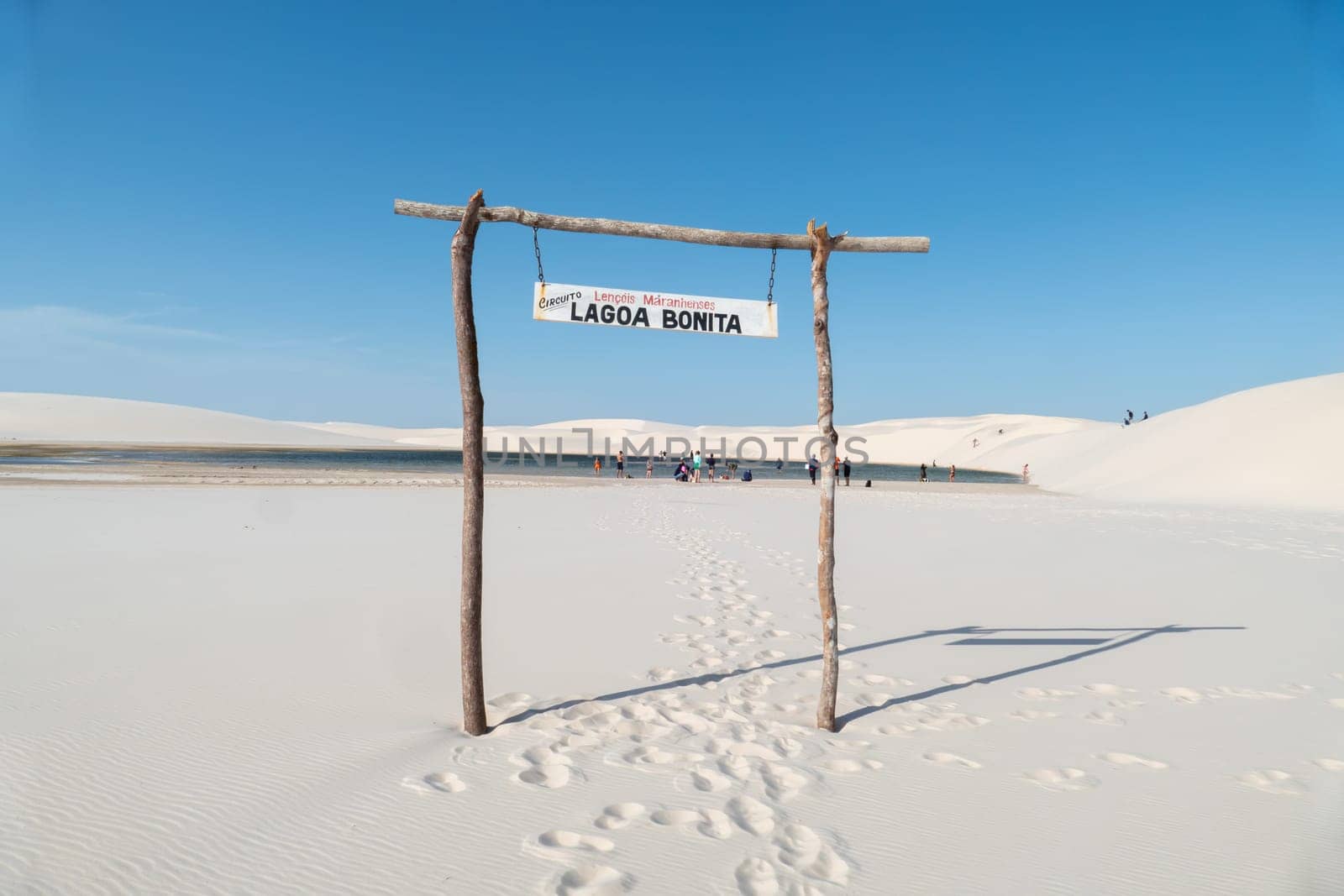 Atins, Brazil - December 23, 2023: people enjoy visiting the lagoa bonita - beautiful sea in the desert dune landscape Lencois Maranhenses National Park - Parque Nacional dos Lencois Maranhenses