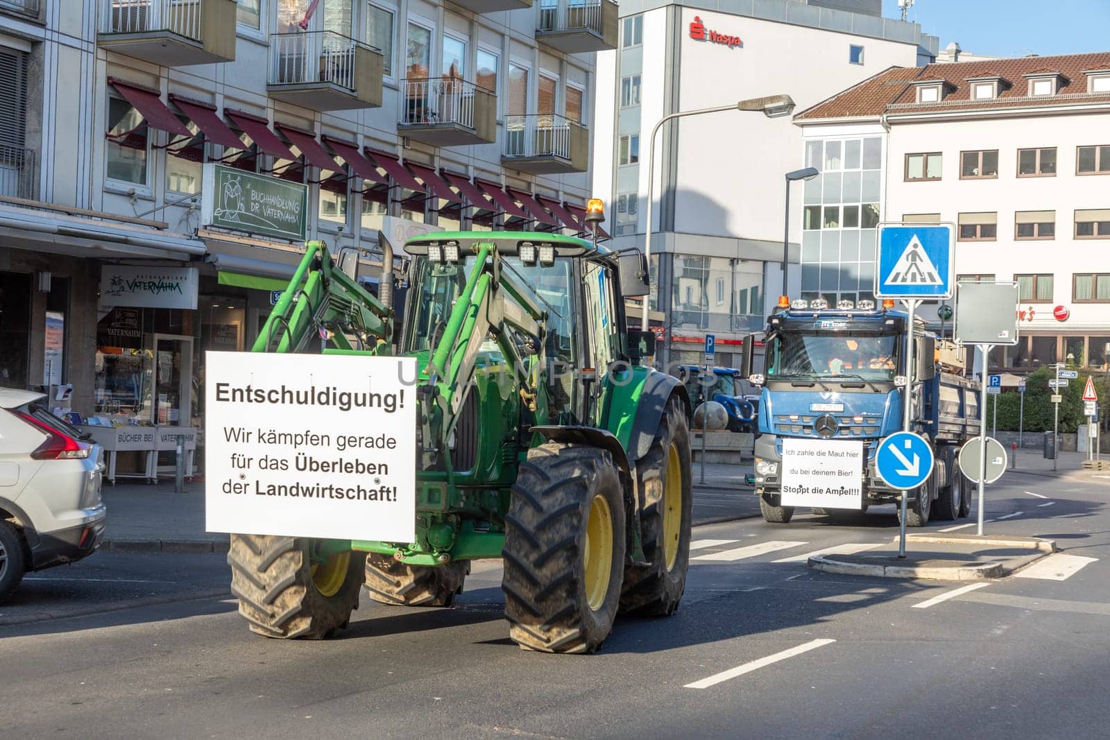 Wiesbaden, Germany - January 8, 2024: farmer with their tractors demonstrate for cutting down the price for diesel fuel and against the german government.with poster sorry, we fight for surviving.