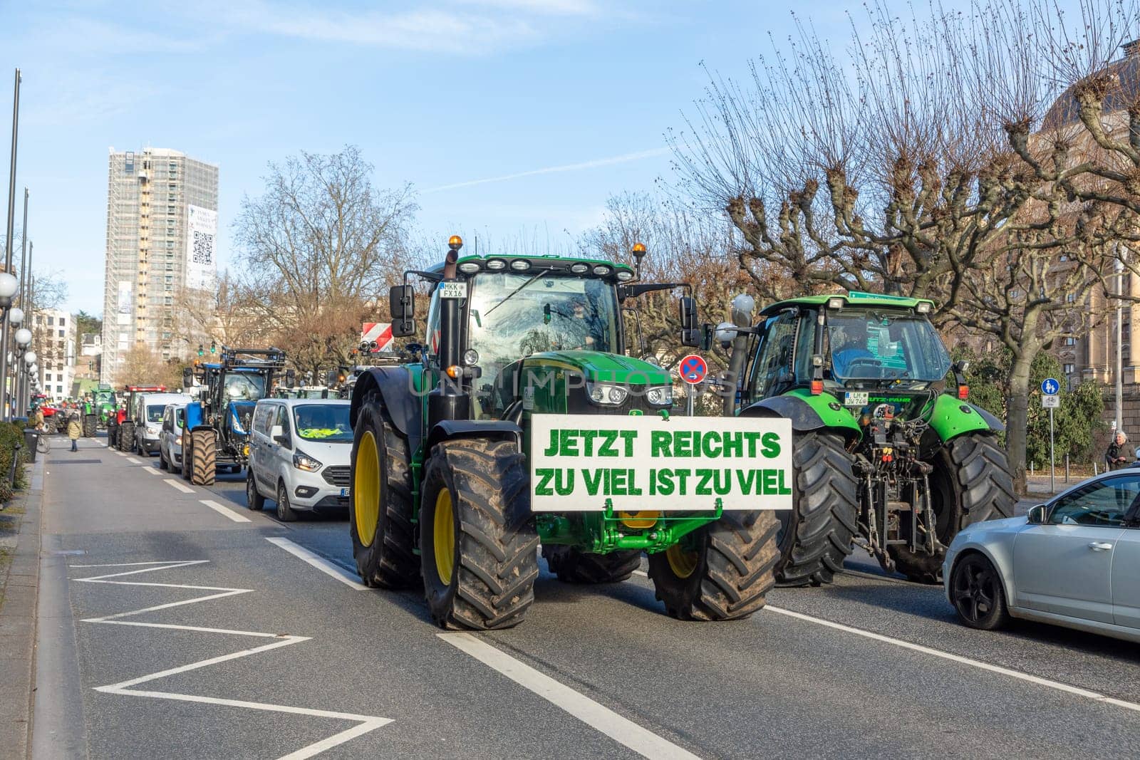 Wiesbaden, Germany - January 8, 2024: farmer with their tractors demonstrate for cutting down the price for diesel fuel and against the german government with poster enough is enought - Jetzt reichts zu viel ist zuviel