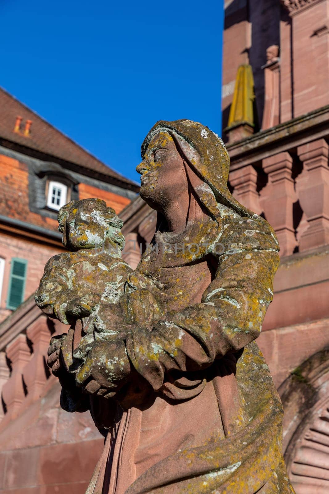 Amorbach, Germany - January 27, 2024: sandstone statue of virgin Mary with child at the Amorbach Abbey church in Bavaria, Germany.