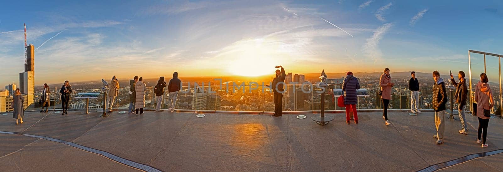 Frankfurt, Germany - February 1, 2024: people enjoy the scenic view to skyline of Frankfurt in dawn from Rhein Main tower.
