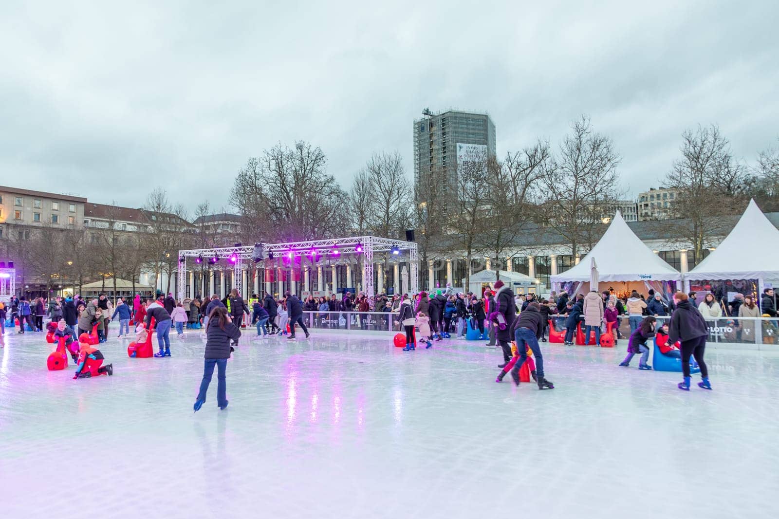 Wiesbaden, Germany - December 29, 2023: people enjoy the rink in front of the kurhaus in Wiesbaden, Hesse, germany.