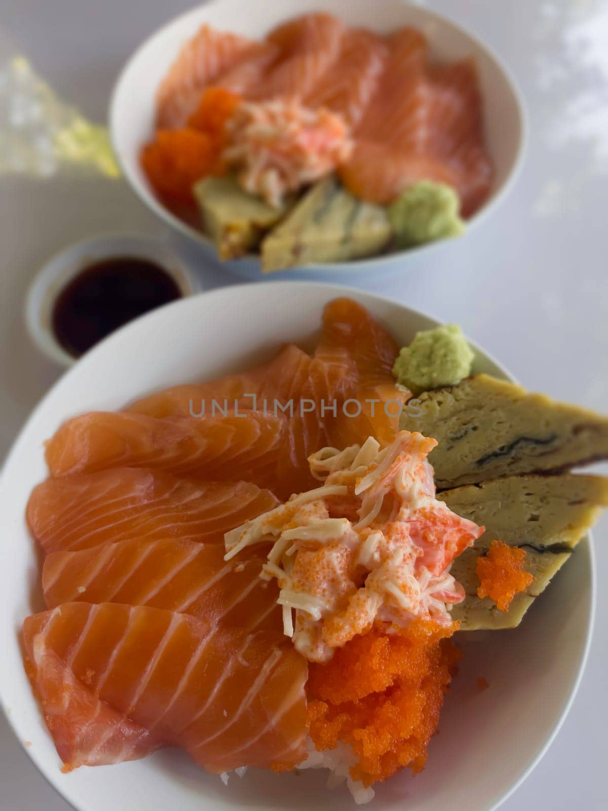 Salmon topped rice served with wasabi and soy sauce, stock photo