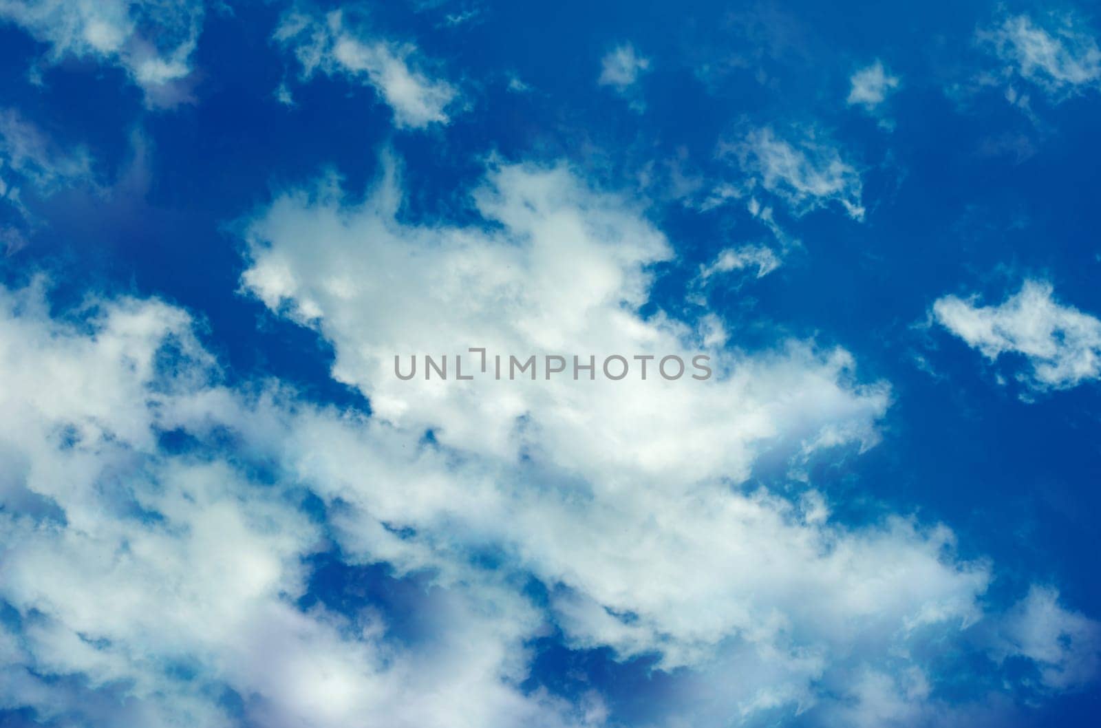High in the sky, white clouds in a close-up on a summer day