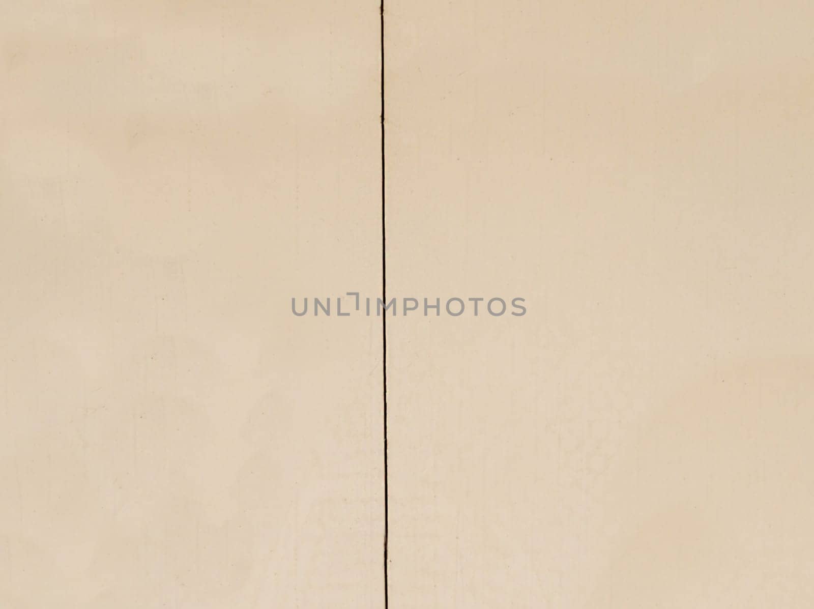 Background texture of a brown wall with a vertical straight crack in close-up