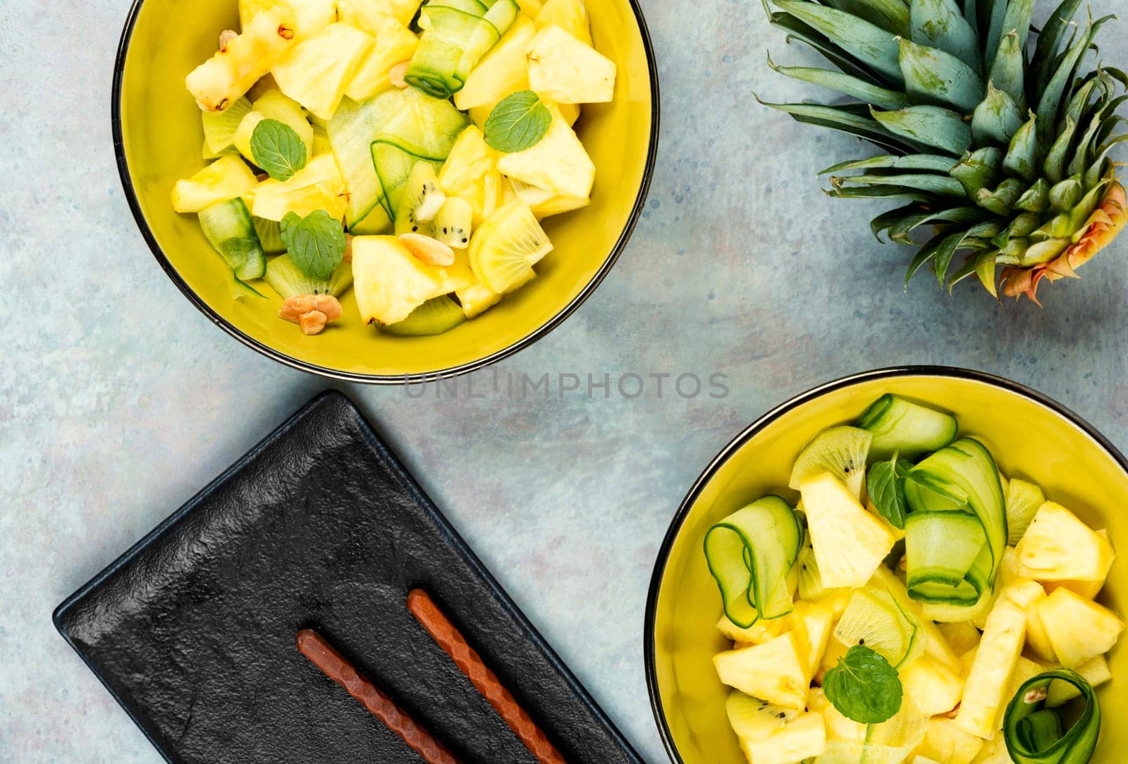 Asian vegan salad with pineapple, nuts and cucumber in a bowl. Weight loss concept.