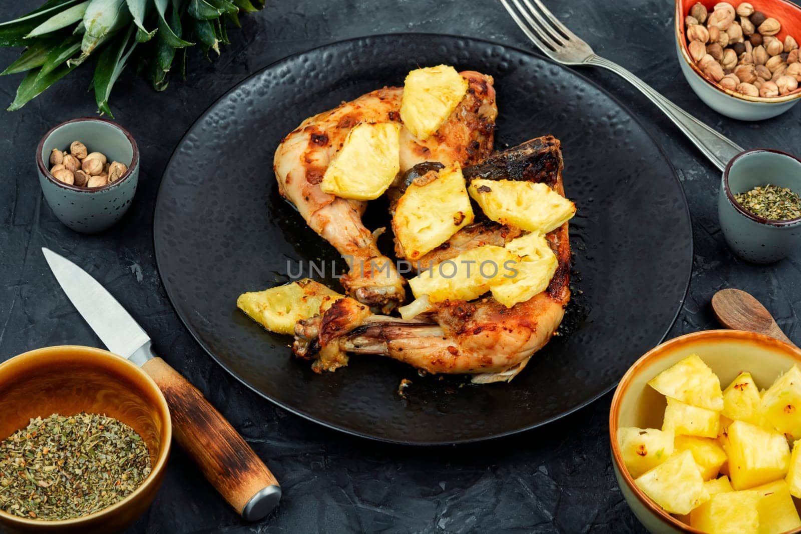 Chicken legs fried with pineapple pieces. Grilled chicken, grilled chicken legs on old wooden table.