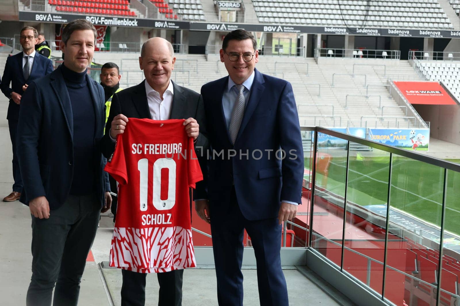 During his visit to Freiburg,Federal Chancellor Olaf Scholz receives a jersey from Jochen Saier (Board Member for Sport SC Freiburg),Oliver Leki (Chief Financial Officer SC Freiburg) and Lord Mayor Martin Horn on the right at the Europa Park Stadium Freiburg