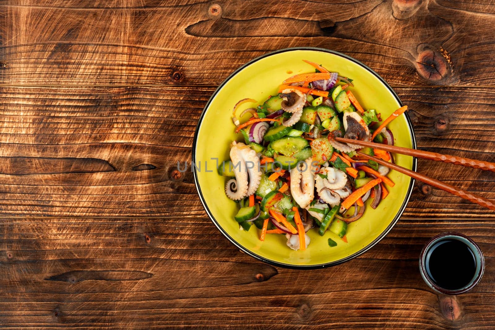 Salad of cucumber, onion and boiled octopus. Korean food. Korean cuisine with seafood