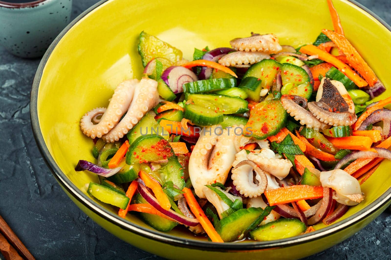 Salad of cucumber, onion and boiled octopus. Korean food. Korean cuisine with seafood