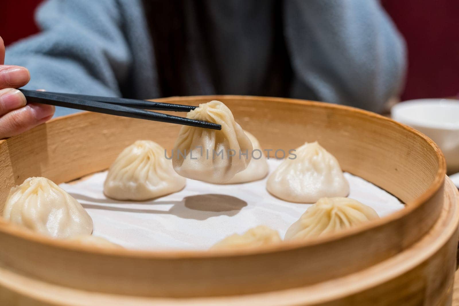 Steamed xiaolongbao served in a traditional steaming basket