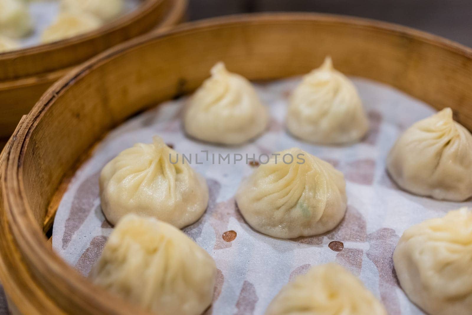 Steamed xiaolongbao served in a traditional steaming basket