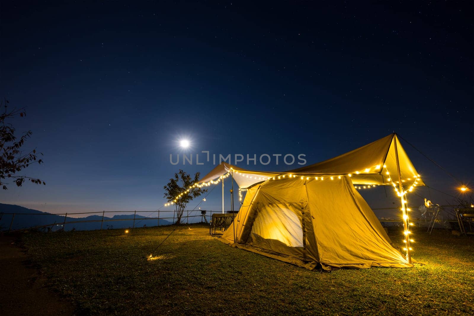 Outdoor camping tent with tarp or flysheet over mountain