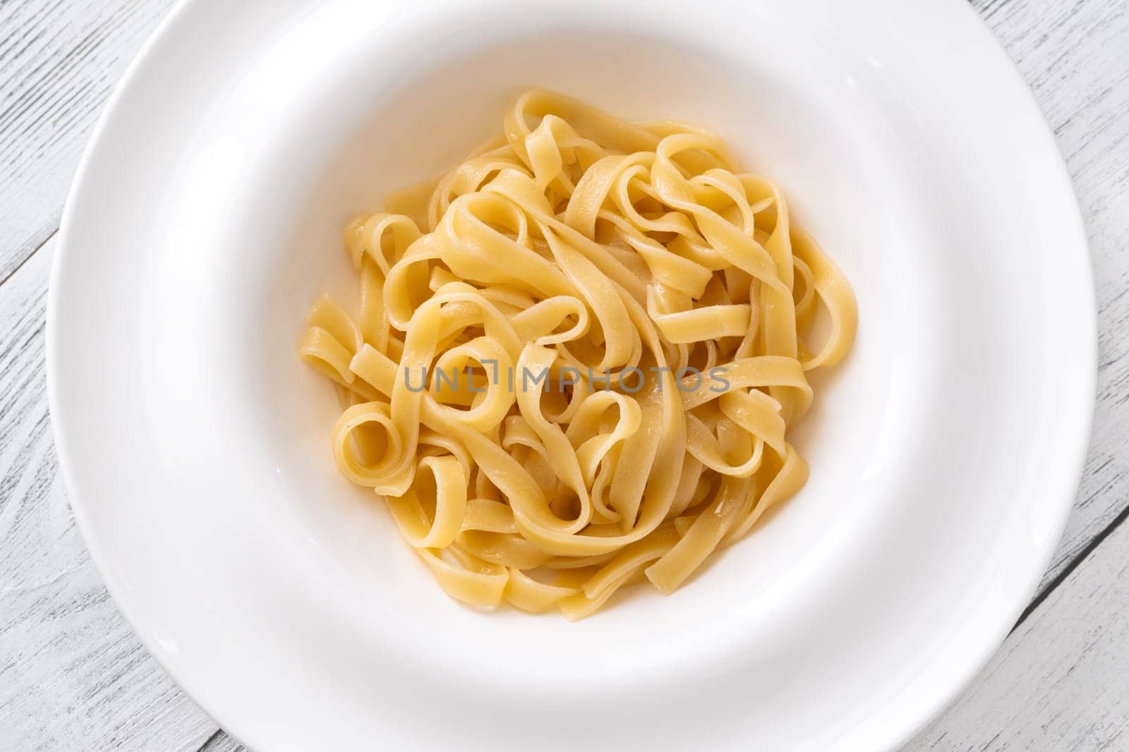 Portion of cooked taglitelle pasta on the plate