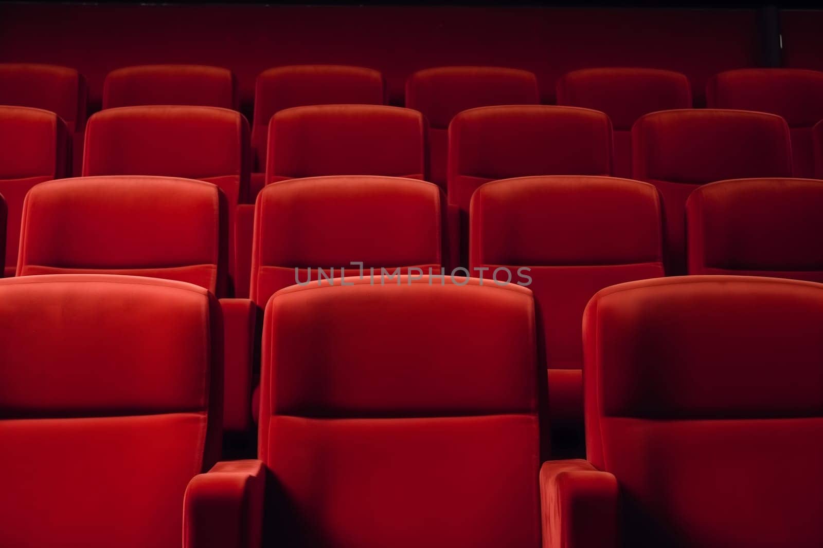 Empty red seats in cinema, domestic intimacy, zoom in, up close. Neural network generated in January 2024. Not based on any actual scene or pattern.