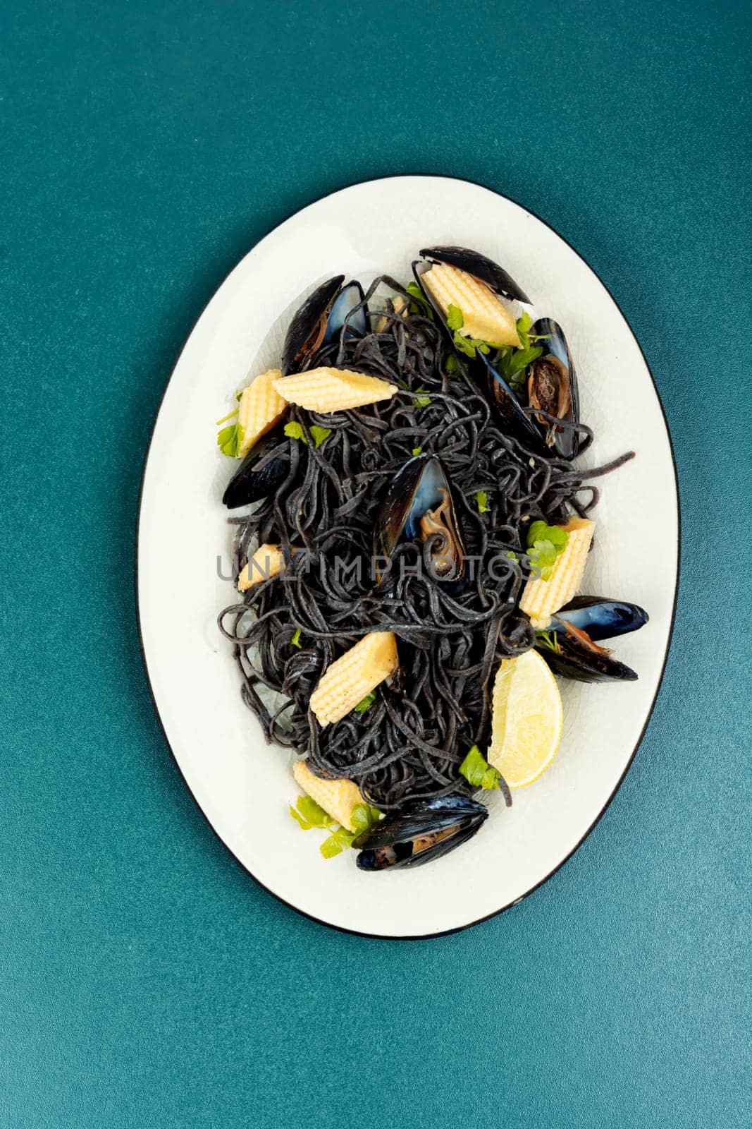 Vegan black bean pasta with mussels. Spaghetti with seafood.