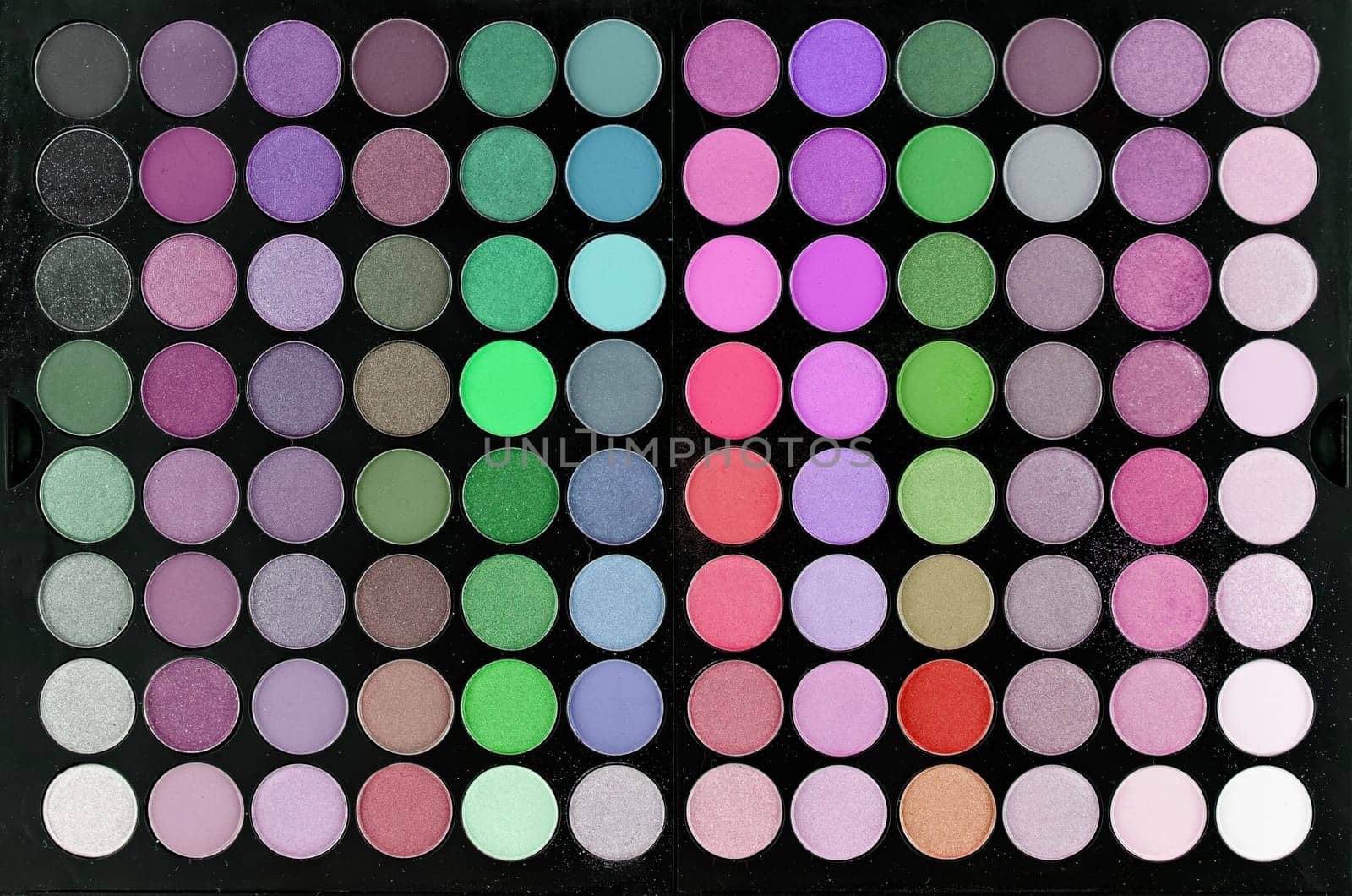 Multi-colored large professional set for face and eye makeup close-up. Texture or background
