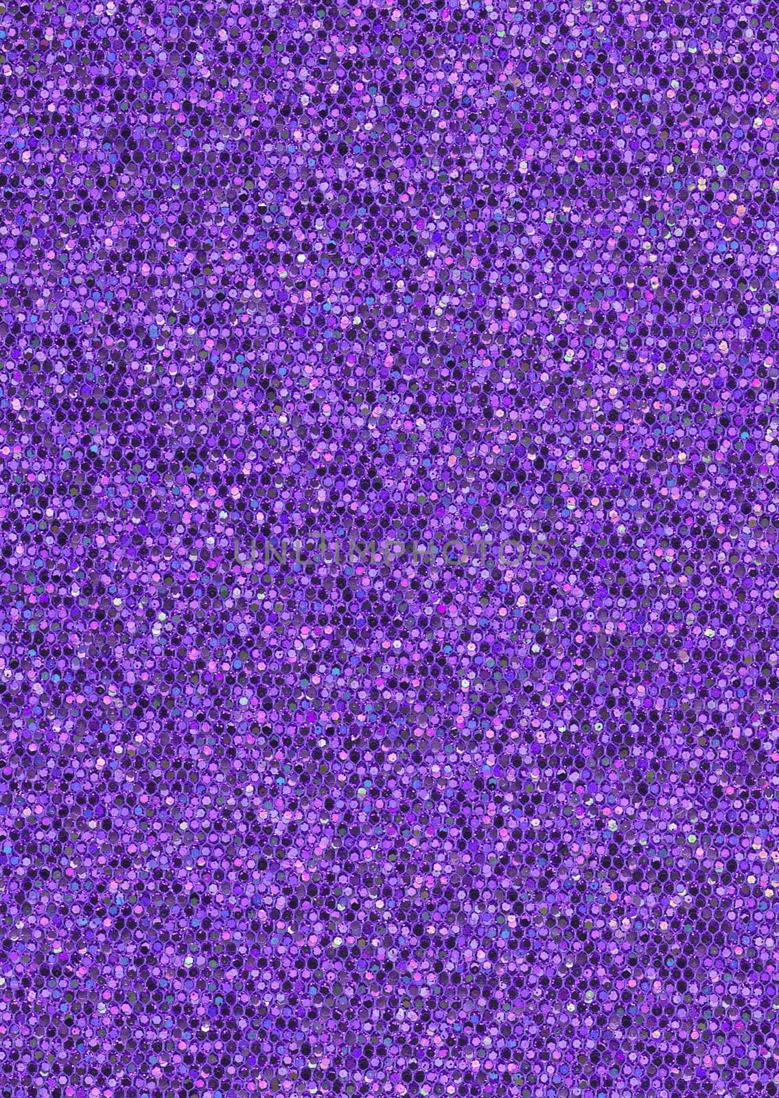 Background image of decorative purple hexagonal sequins in close-up