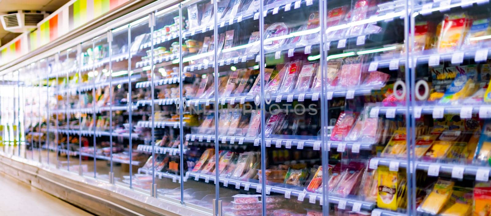 LEUVEN, BELGIUM - AUG 26, 2022: Food products displayed in a commercial refrigerator in supermarket