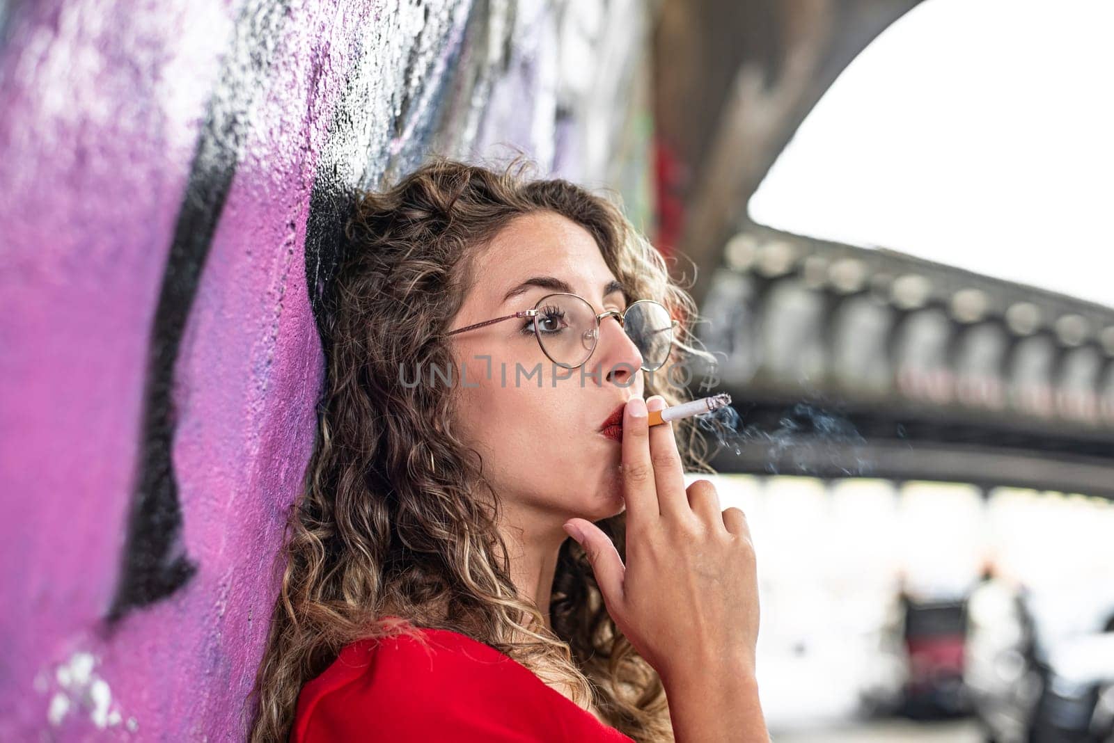 pensive young woman with cigarette